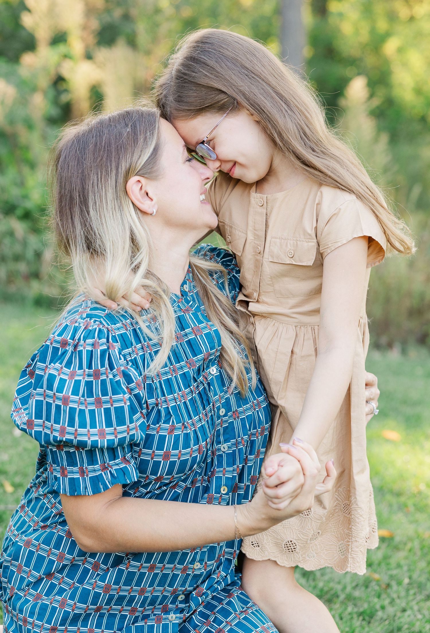 A tender moment captured in a series of outdoor photos showing two people embracing in a sunny garden setting.