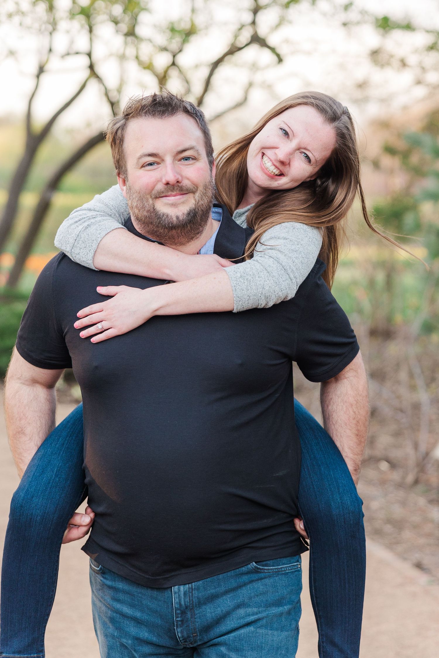 Joyful piggyback moment captured on nature trail.