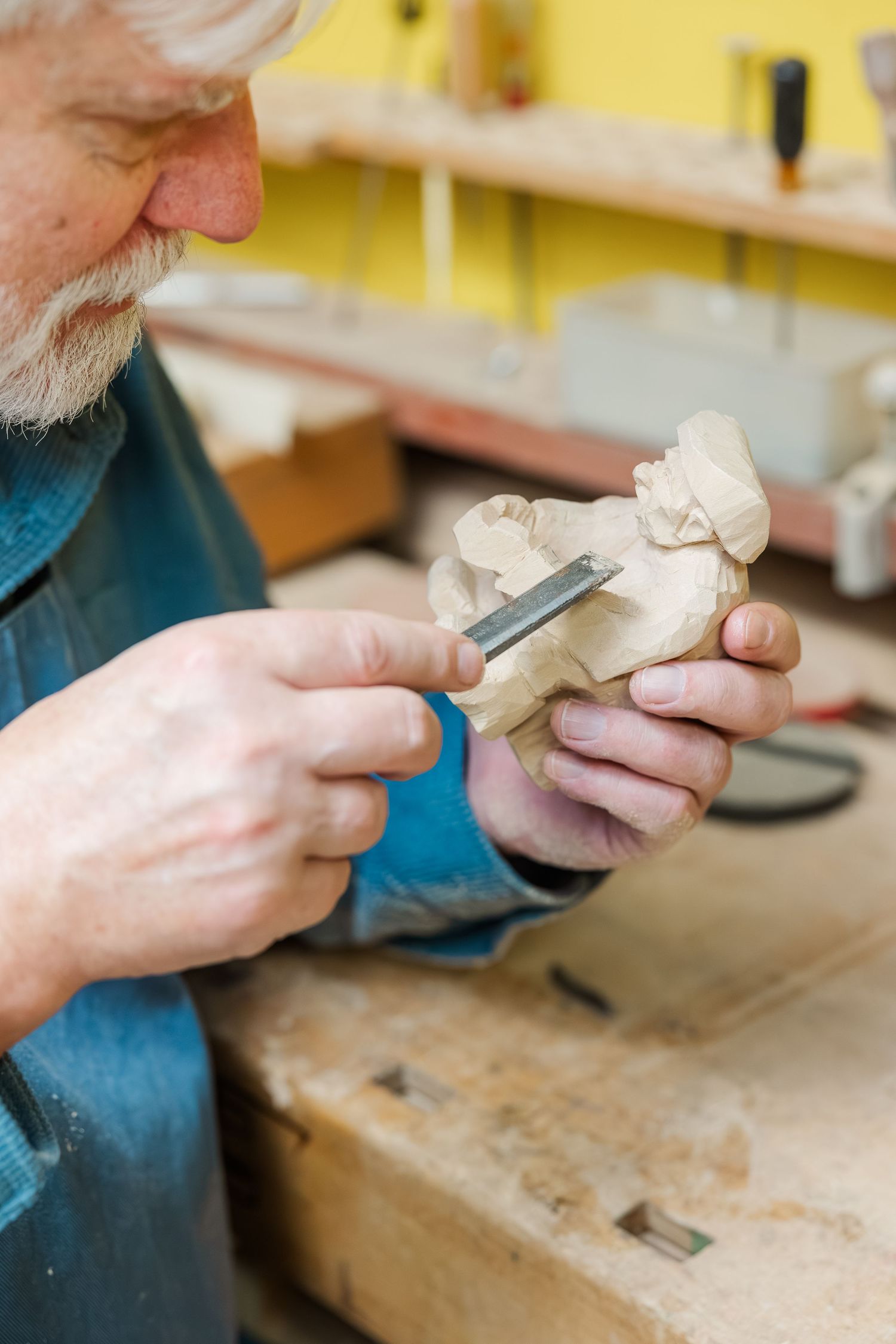 Beacon Hill senior living branding photo in Lombard, Illinois featuring resident carving wood in workshop
