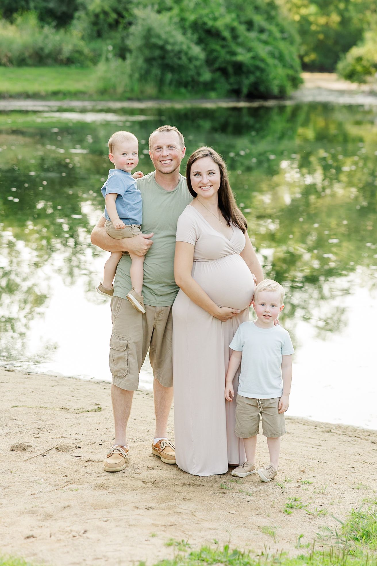 Family maternity portrait with parents and children by the water at Shamrock Hills Park in Crystal Lake IL