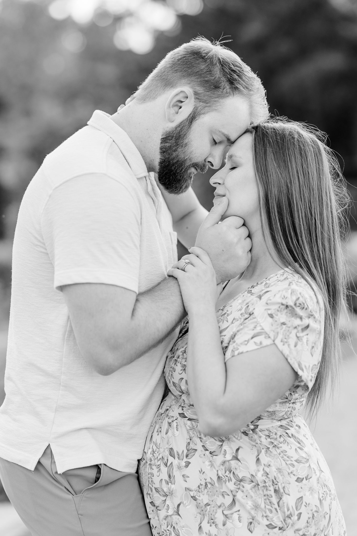 Black and white close-up maternity portrait of expecting parents cuddling during their Cantigny Park session