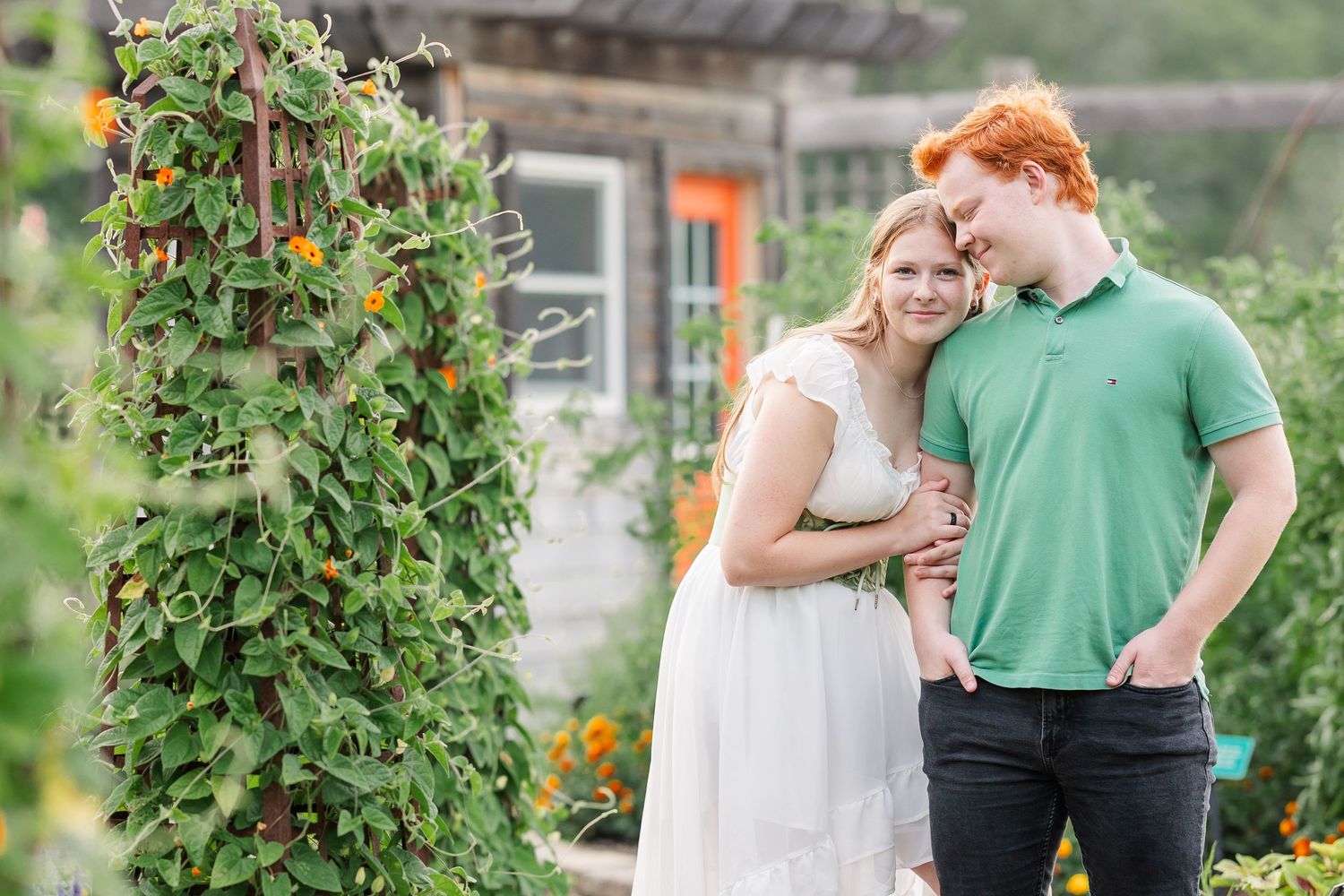 Samantha leans against Carl during a joyful summer portrait surrounded by the Cantigny Park gardens.