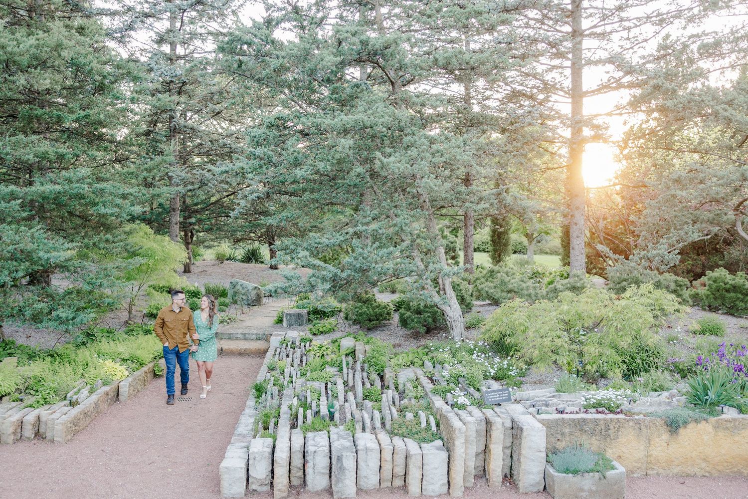Wide engagement photo walking through the gardens at Cantigny Park