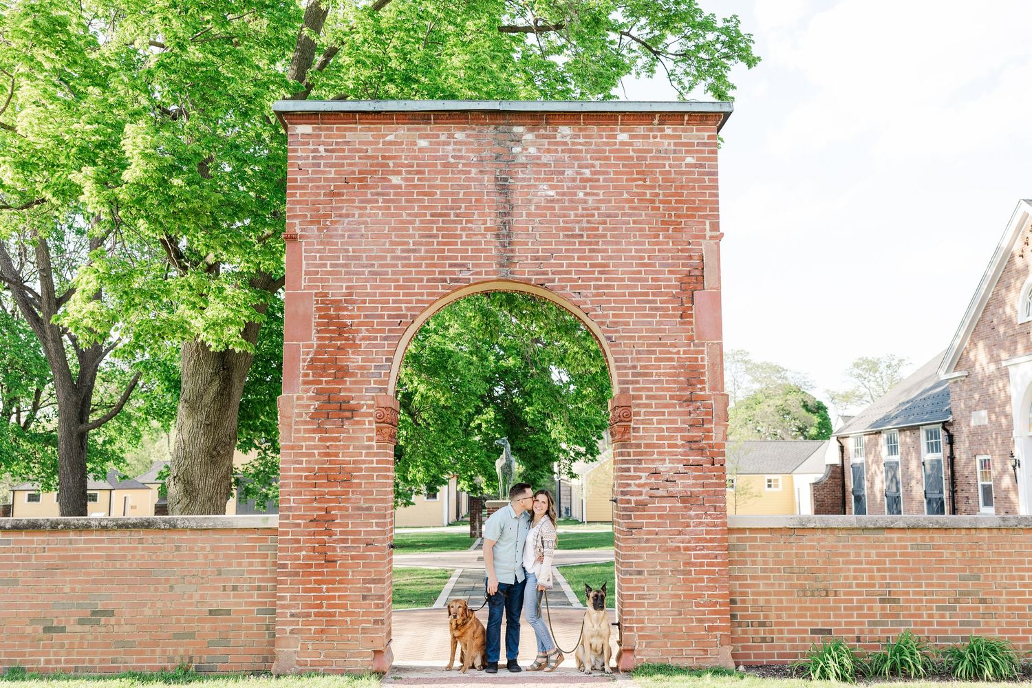 St. James Farm Preserve engagement photos with dogs under the brick arch