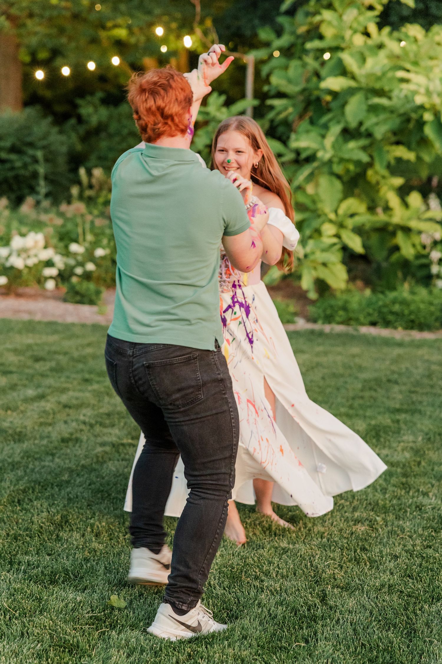 Samantha and Carl dance together after getting covered in paint during her fun Cantigny Park senior session.