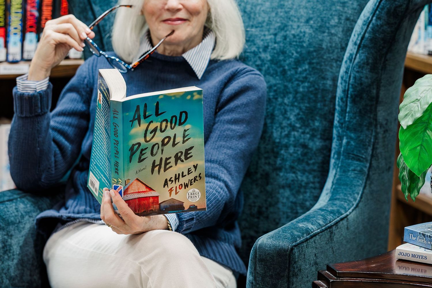 Beacon Hill senior living branding photo in Lombard, Illinois featuring resident reading in library chair