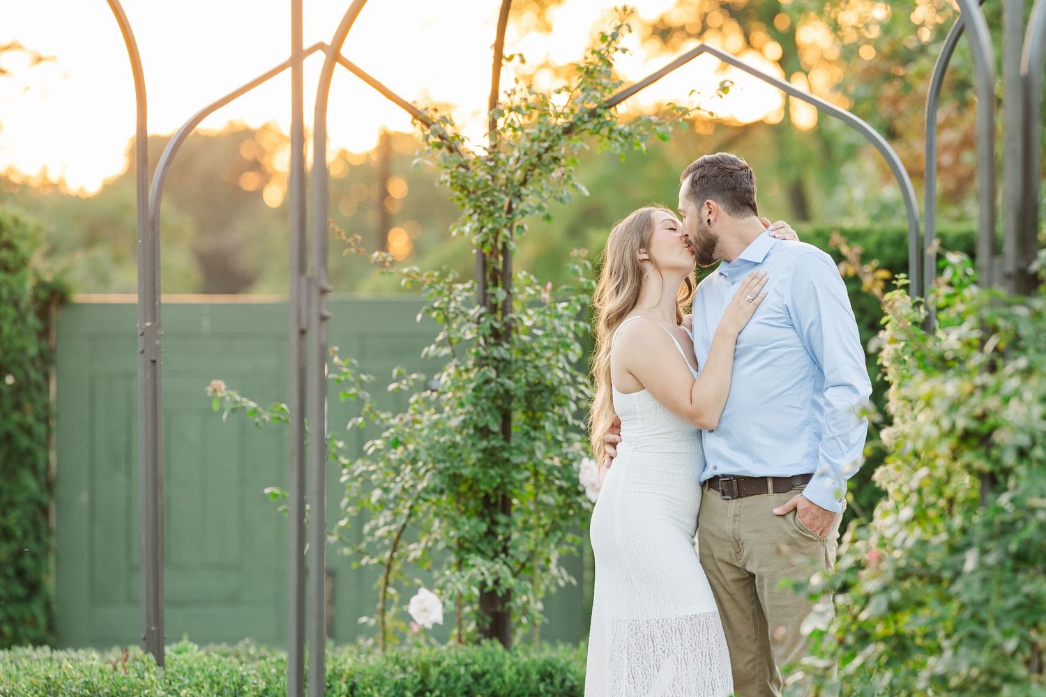 Couple kissing in garden during engagement photos at Cantigny Park in Wheaton, Illinois