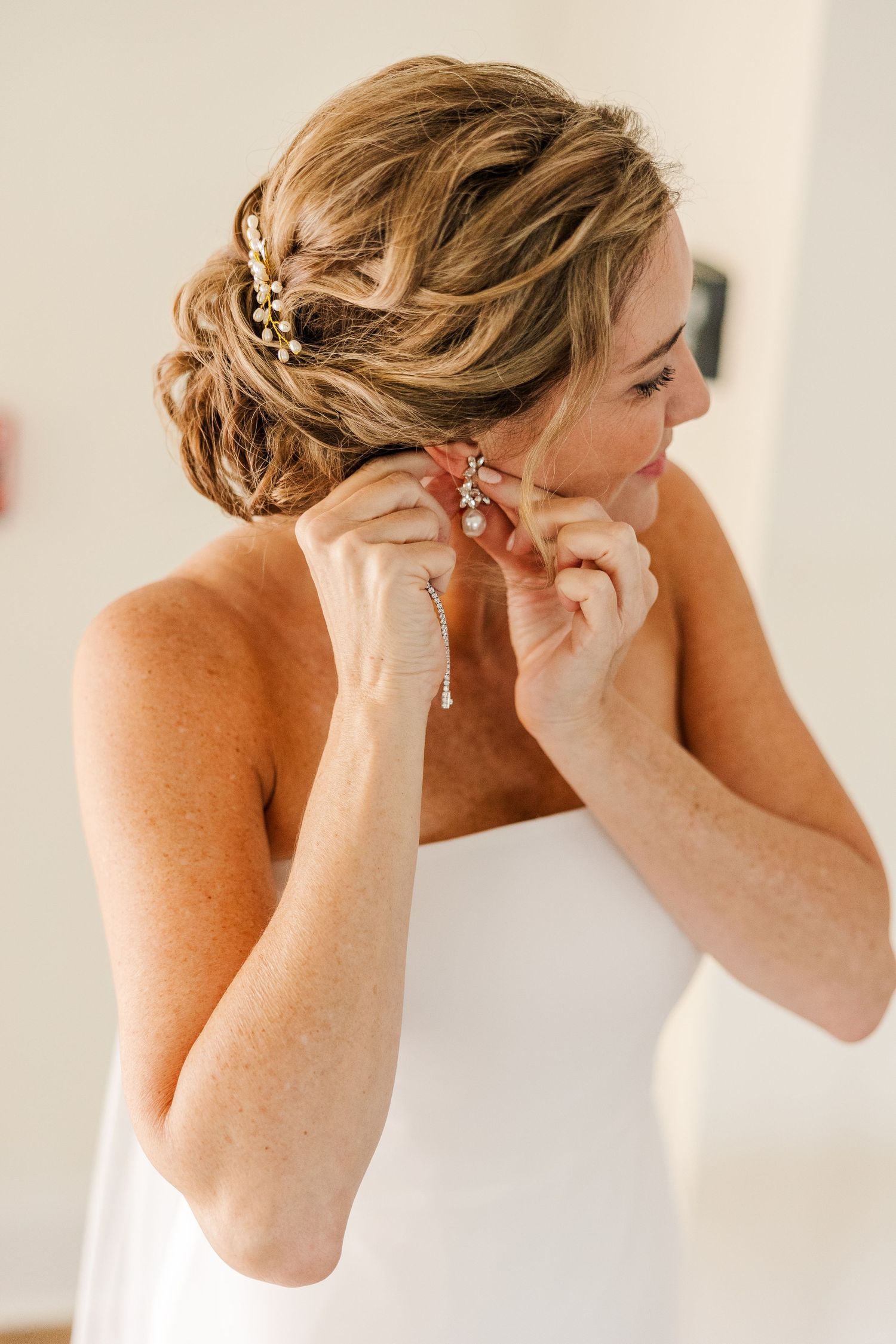 Close-up of an elegant updo hairstyle with pearl accessories.