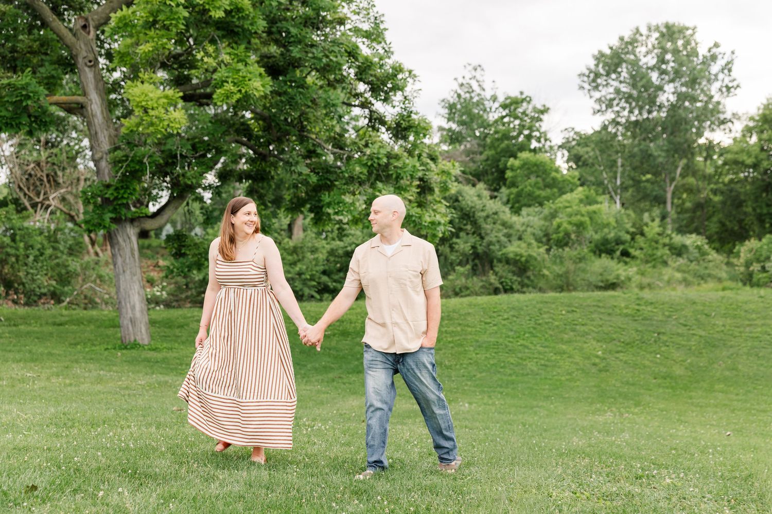 Parents walking hand in hand during a family photography session in Crystal Lake, Illinois.