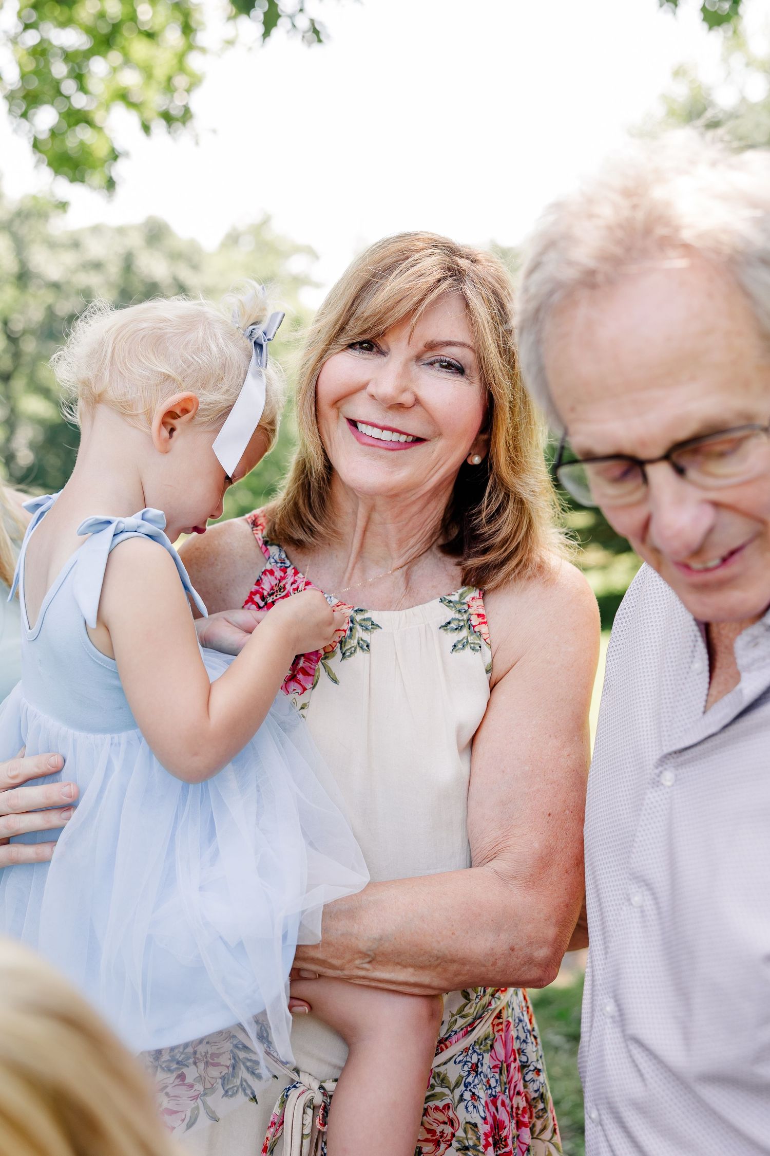 Grandmother holding a little girl during a sweet summer family reunion session in Crystal Lake, IL.