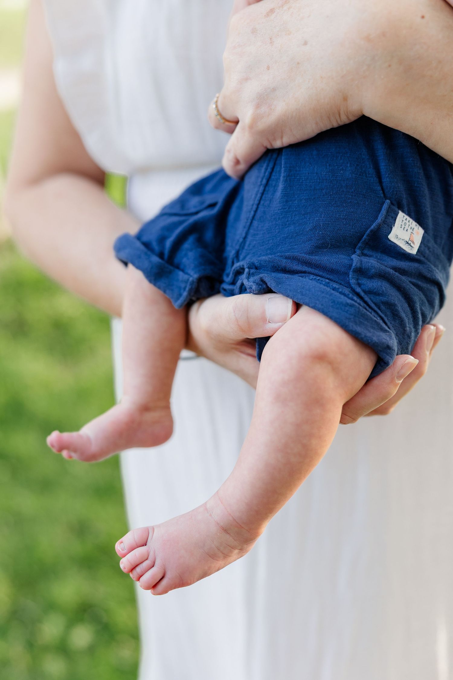 Tiny baby feet during an outdoor family portrait session at Veterans Acres Nature Center in Crystal Lake, Illinois