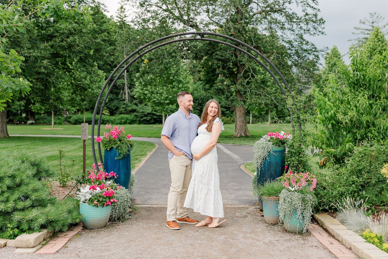Expecting parents standing near the garden entrance at Cantigny Park in Wheaton