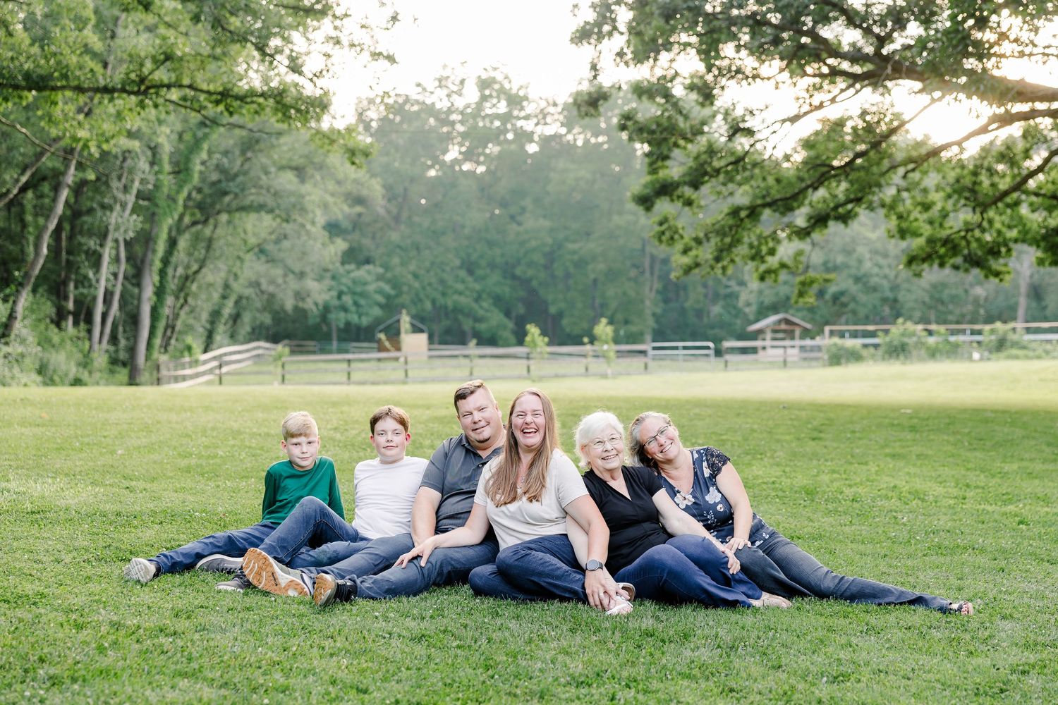 Extended family sitting together on a blanket at their home in Bull Valley, Illinois.