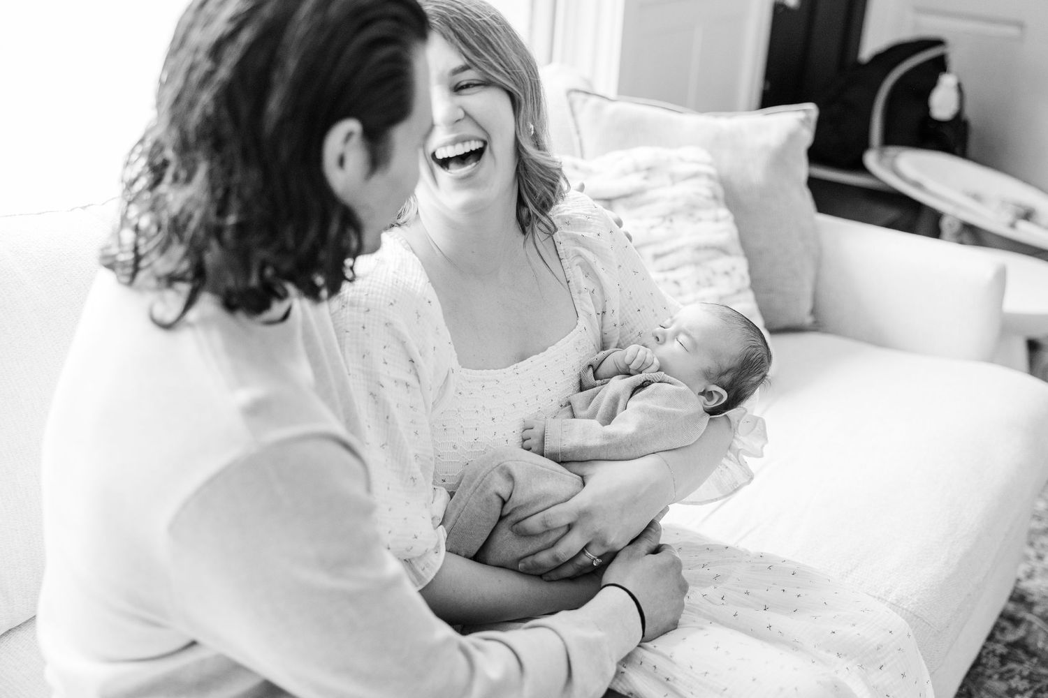 Palatine IL lifestyle newborn photographer capturing parents holding their sleeping baby during a relaxed in-home newborn session