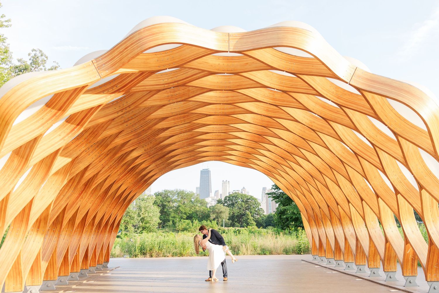 Elizabeth and Joe standing under the Honeycomb Pavilion in Lincoln Park, Chicago, dancing with each other