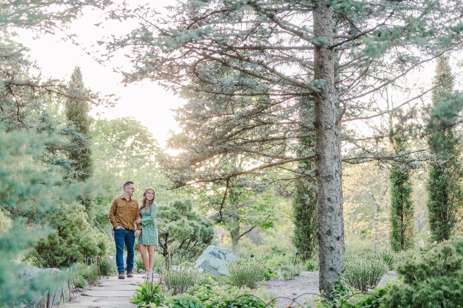 Romantic Cantigny Park engagement photo surrounded by garden greenery