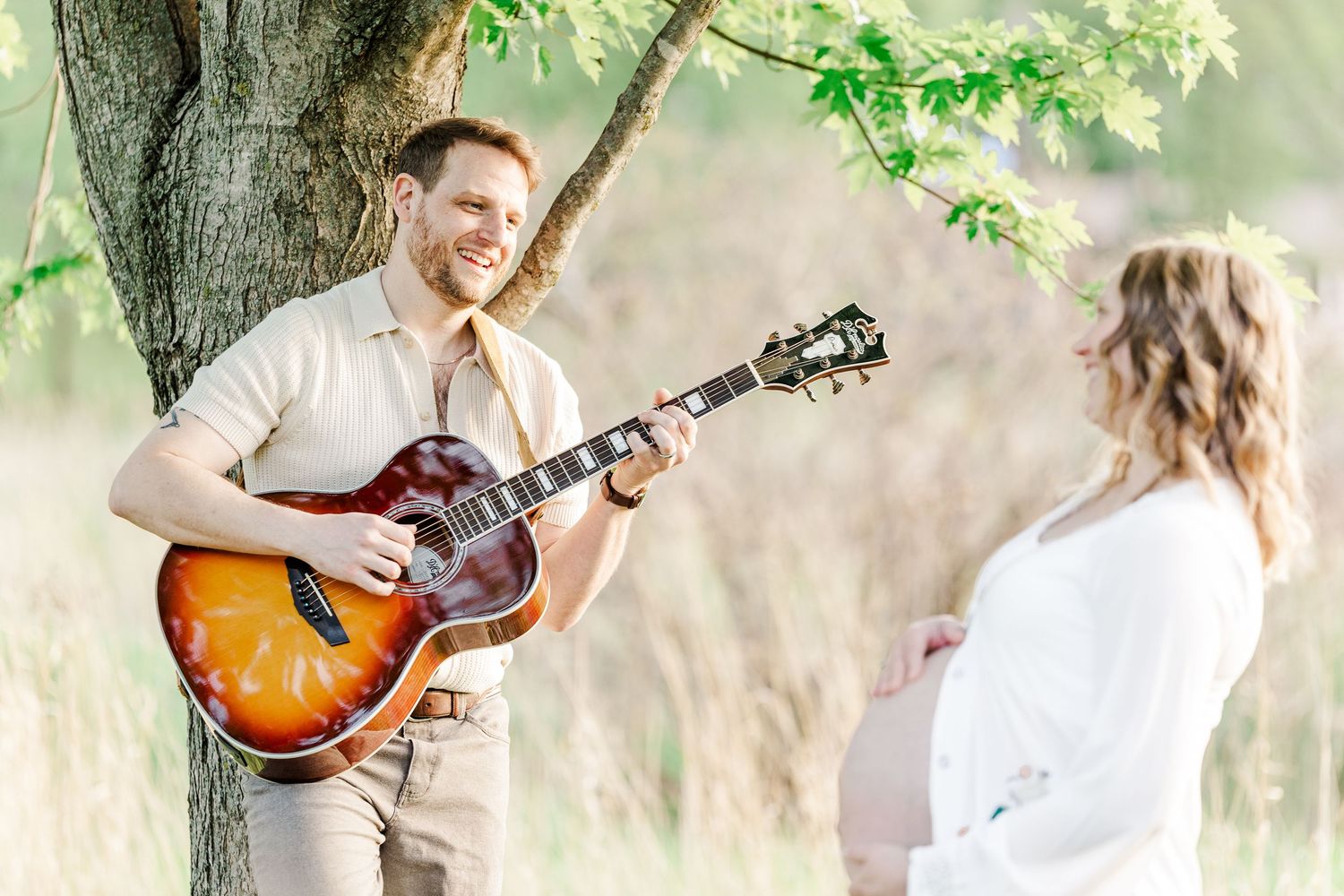 Music-inspired maternity photo with father playing guitar at Veterans Acres Nature Preserve.