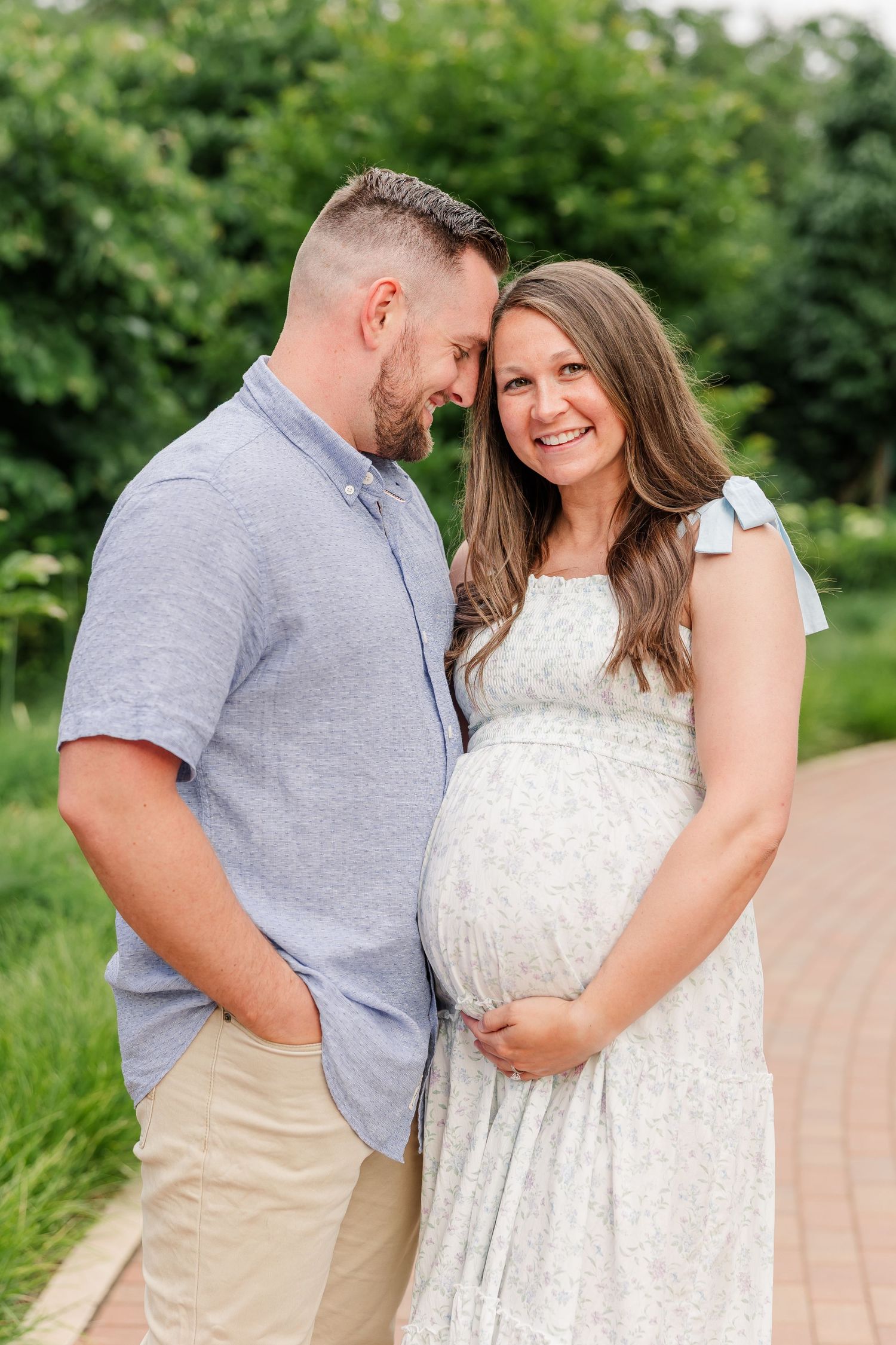 Expecting parents cuddling together during a sweet Cantigny Park maternity session