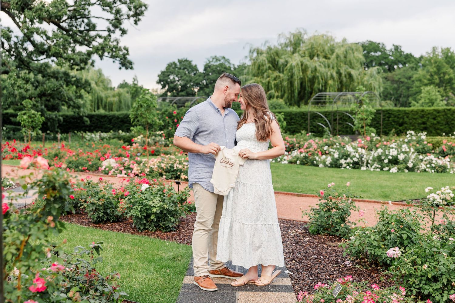 Expecting parents kissing in the rose garden during a Cantigny Park maternity session