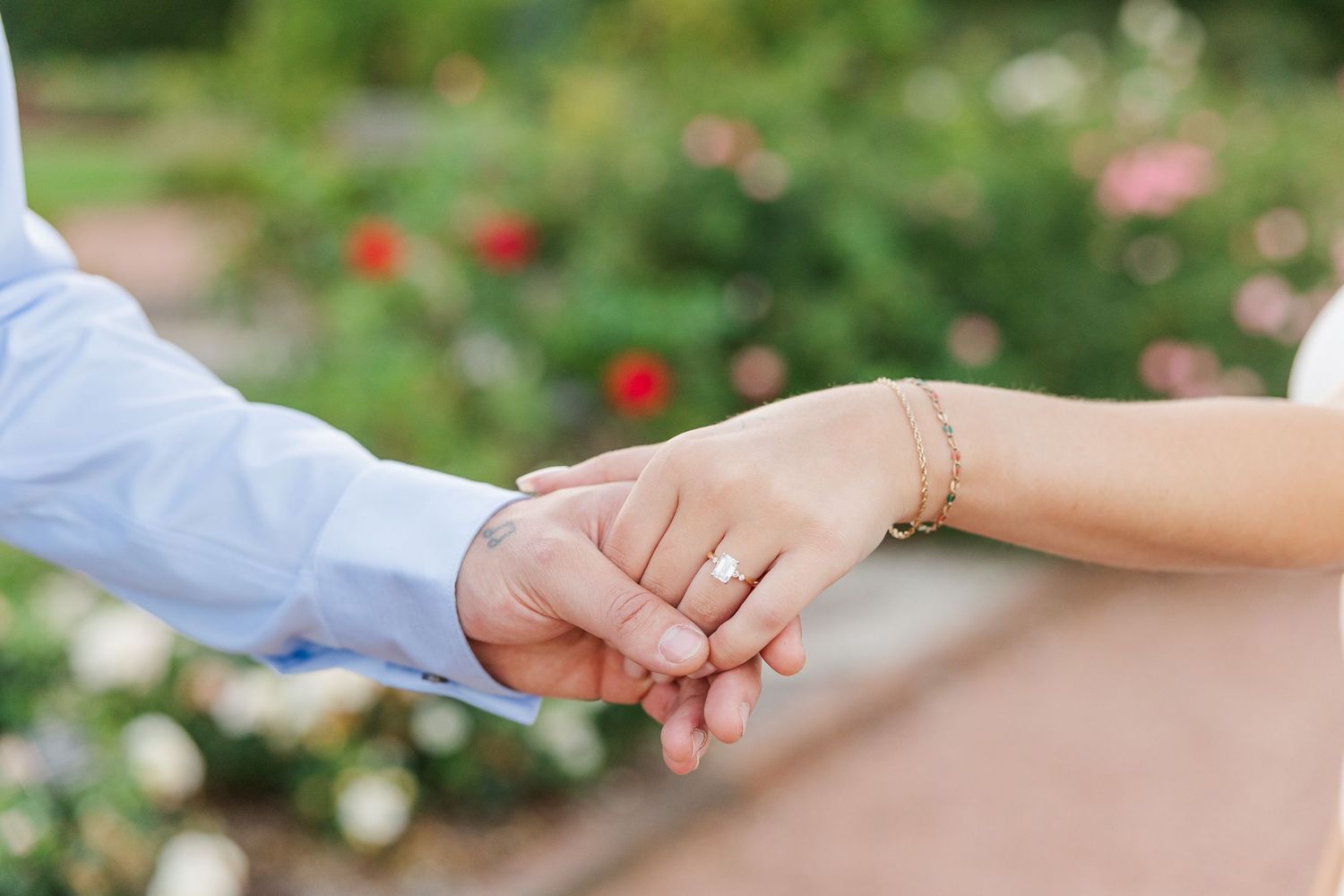 Close-up of couple holding hands during engagement photos at Cantigny Park in Wheaton, Illinois
