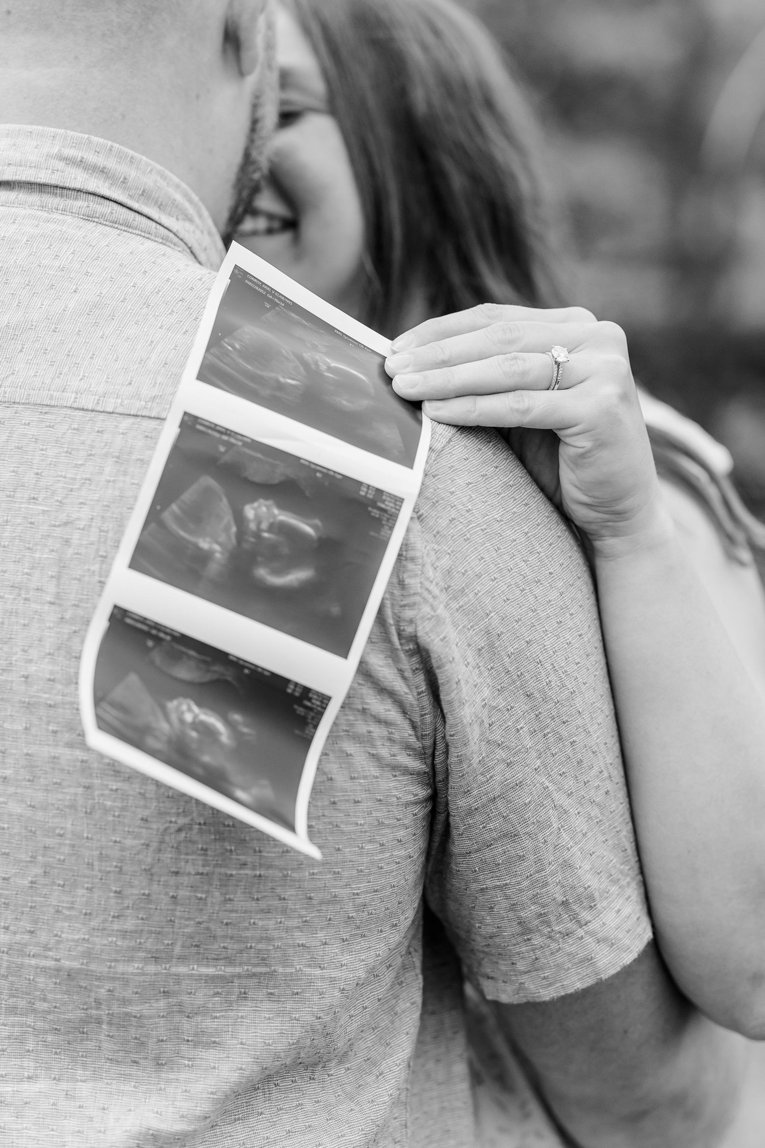 Black and white detail photo of ultrasound photos during a maternity session