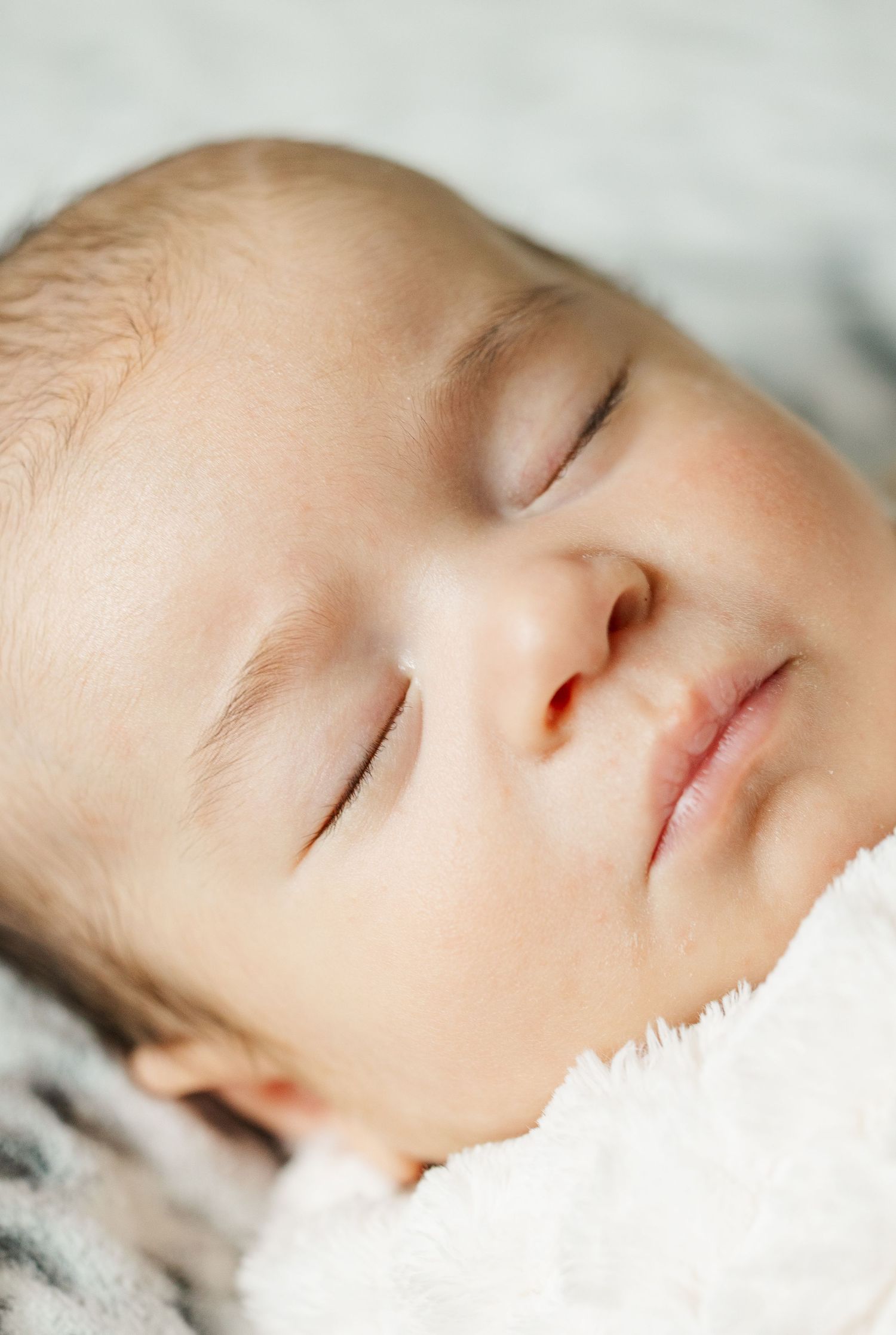 Close-up of peacefully sleeping newborn during an in-home lifestyle newborn session in Palatine Illinois.