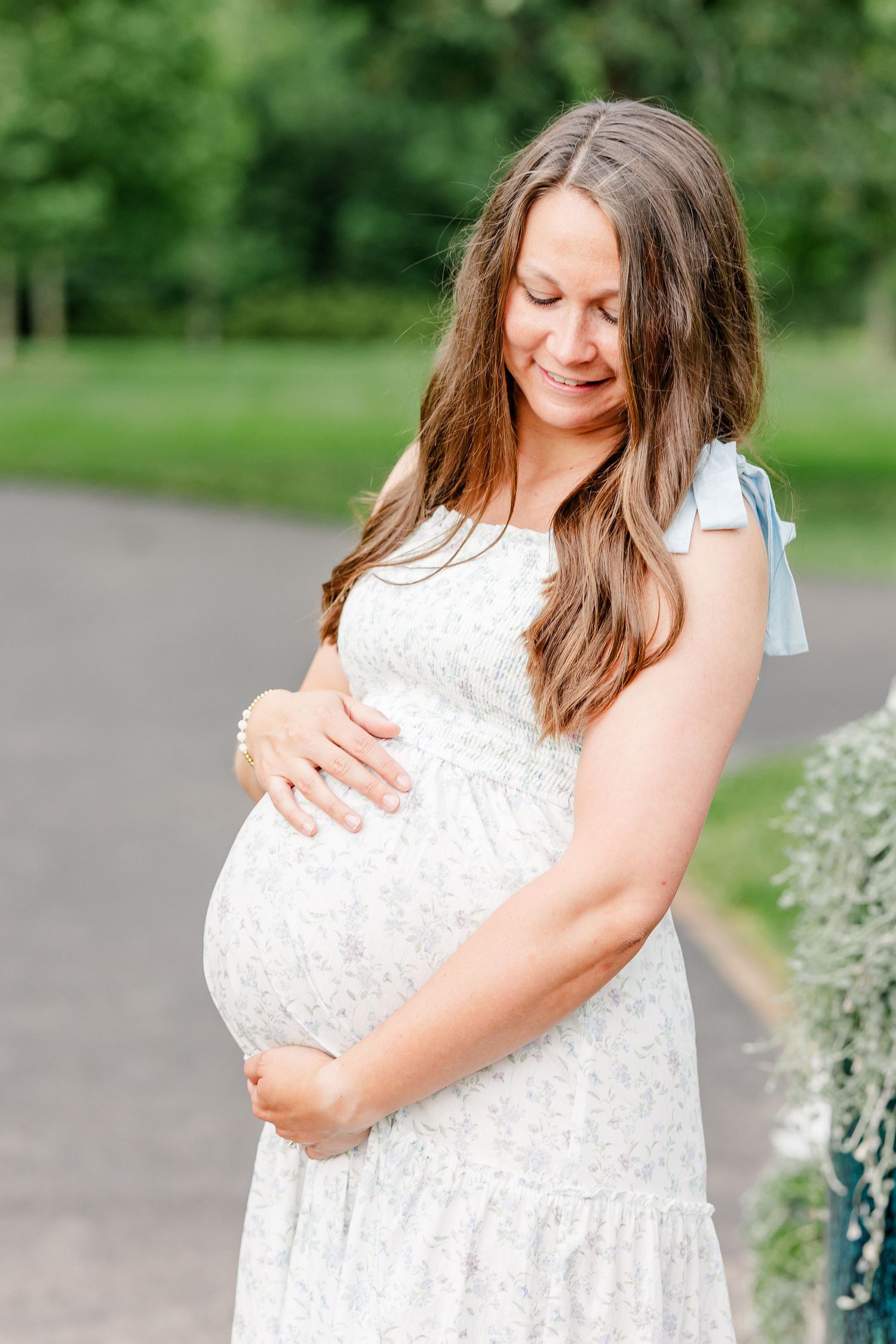 Beautiful expecting mother holding her baby bump during a Cantigny Park maternity session