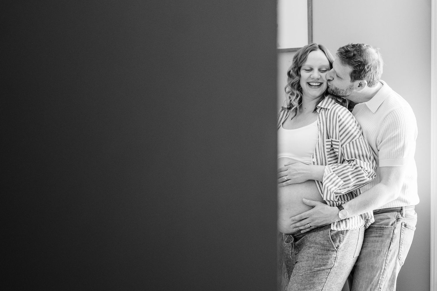 Black and white maternity portrait in a twin boys’ nursery during an in-home session in Crystal Lake.
