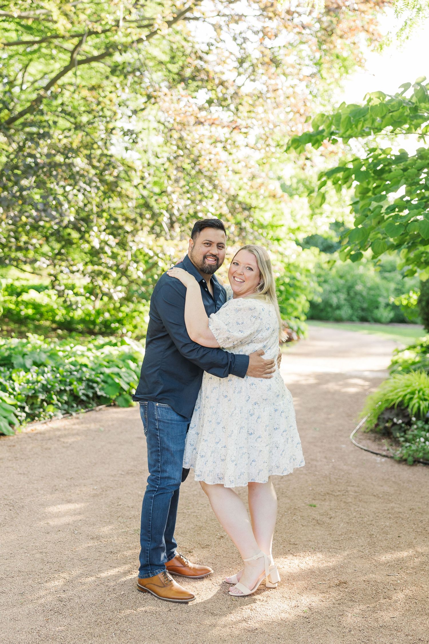 A joyful moment captured on a garden path beneath blooming spring trees.