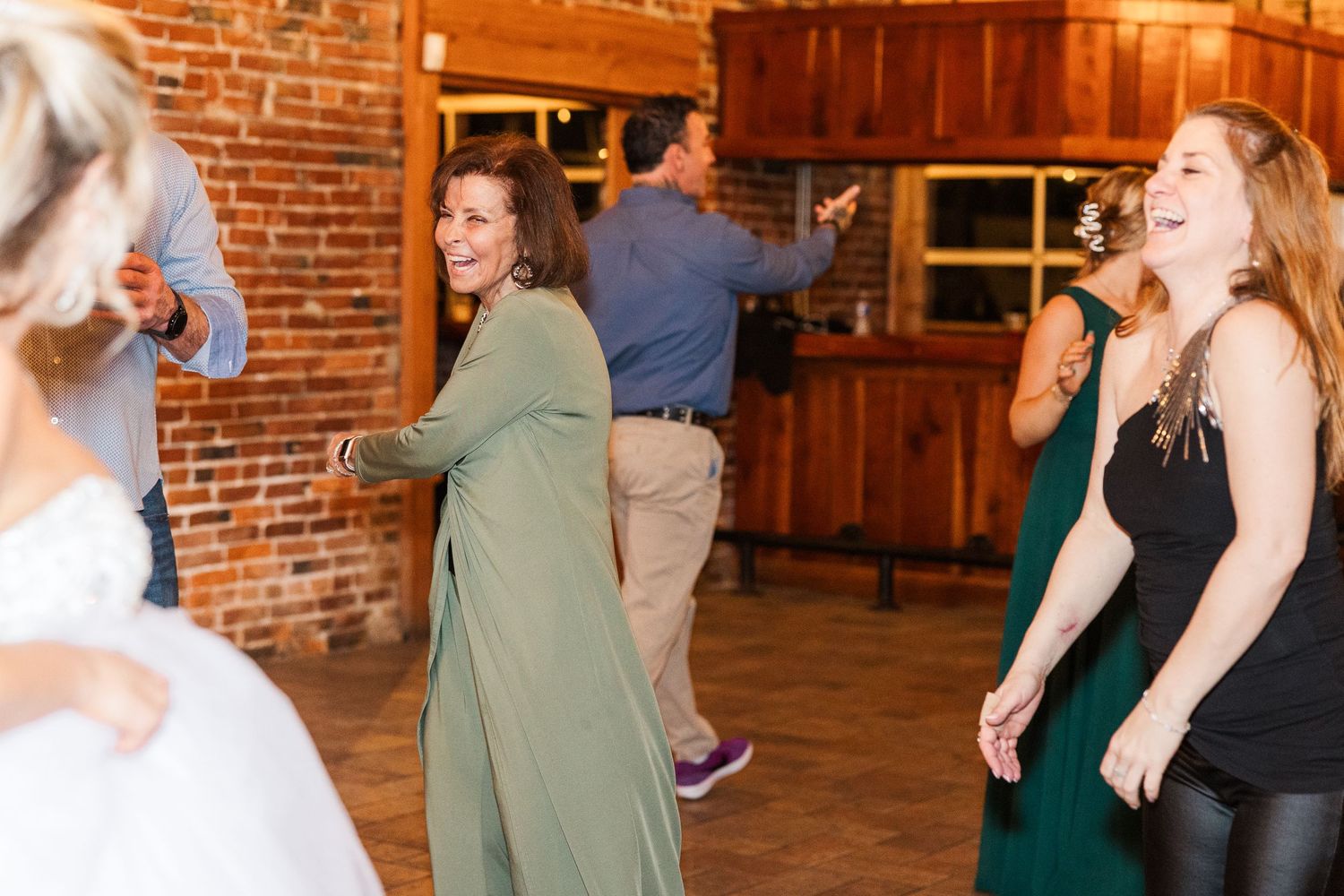 Wedding guests dancing and having fun at rustic reception venue.