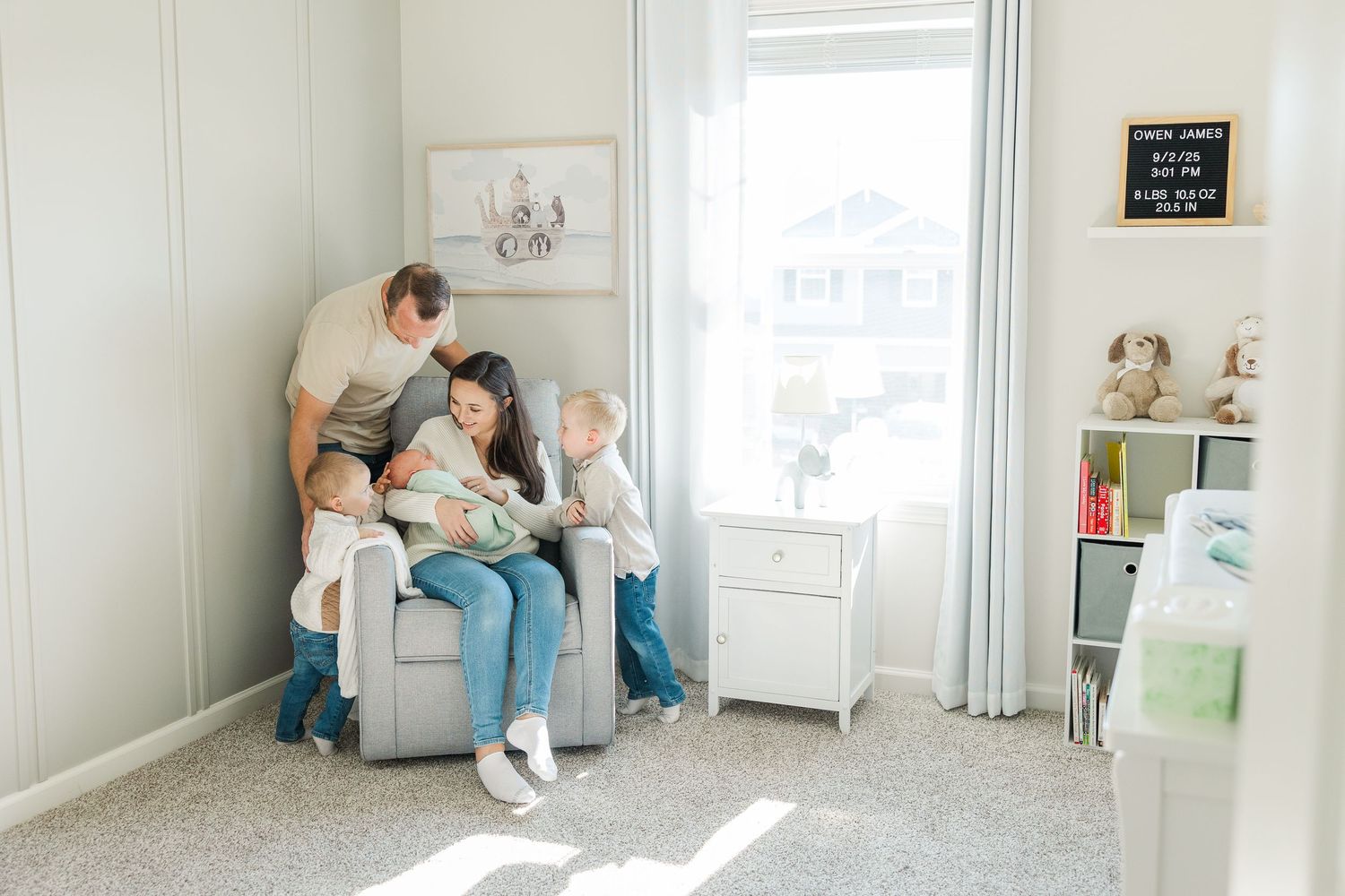 In-home lifestyle newborn family session in Wonder Lake, Illinois with parents, newborn, and two young boys