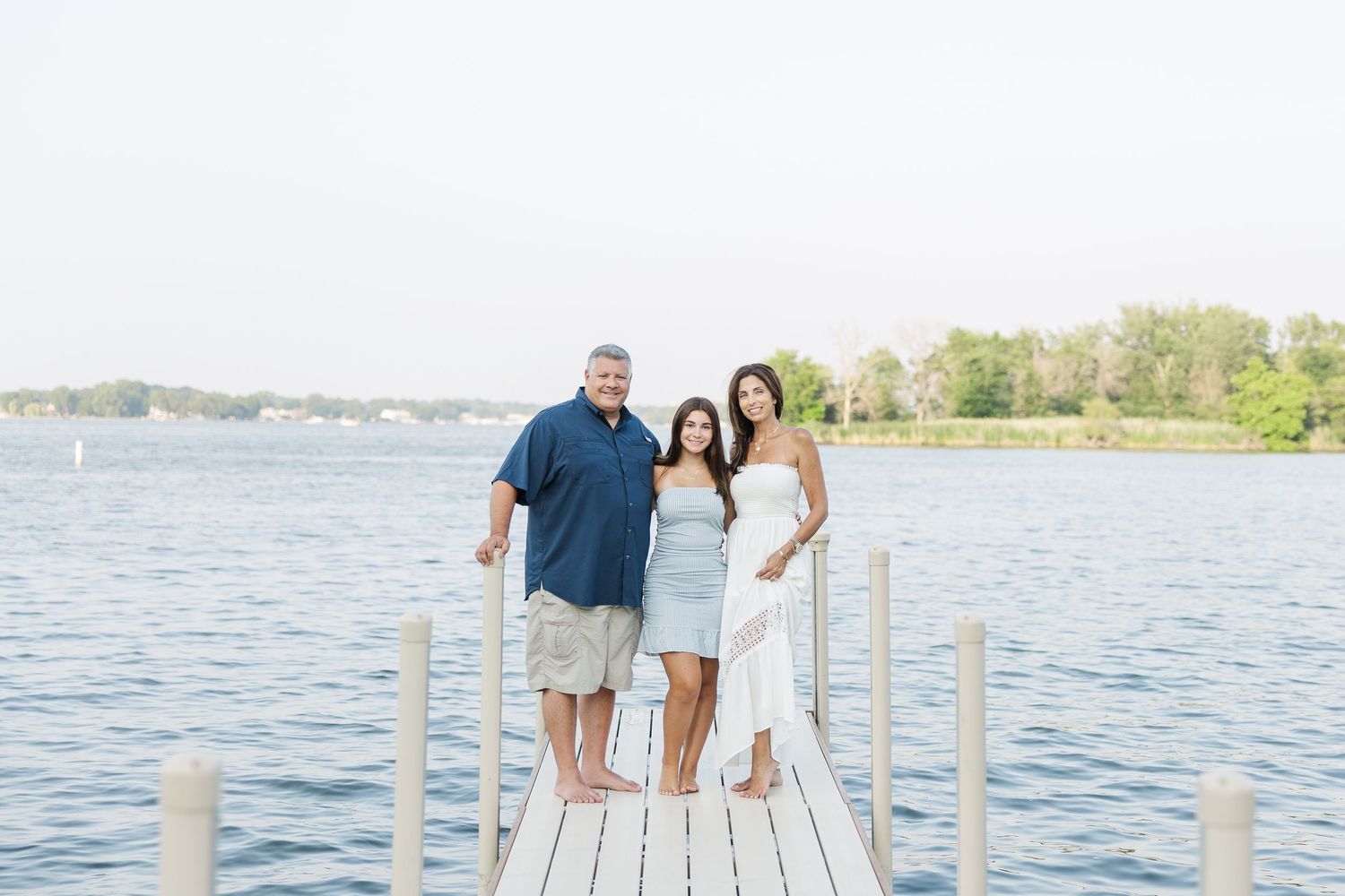 Family standing on dock during Pistakee Lake family photos in Johnsburg, Illinois