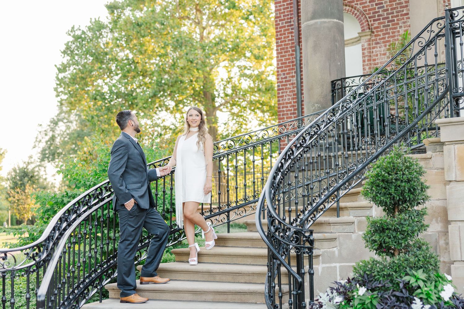 Couple walking by staircase during engagement photos at Cantigny Park in Wheaton, Illinois