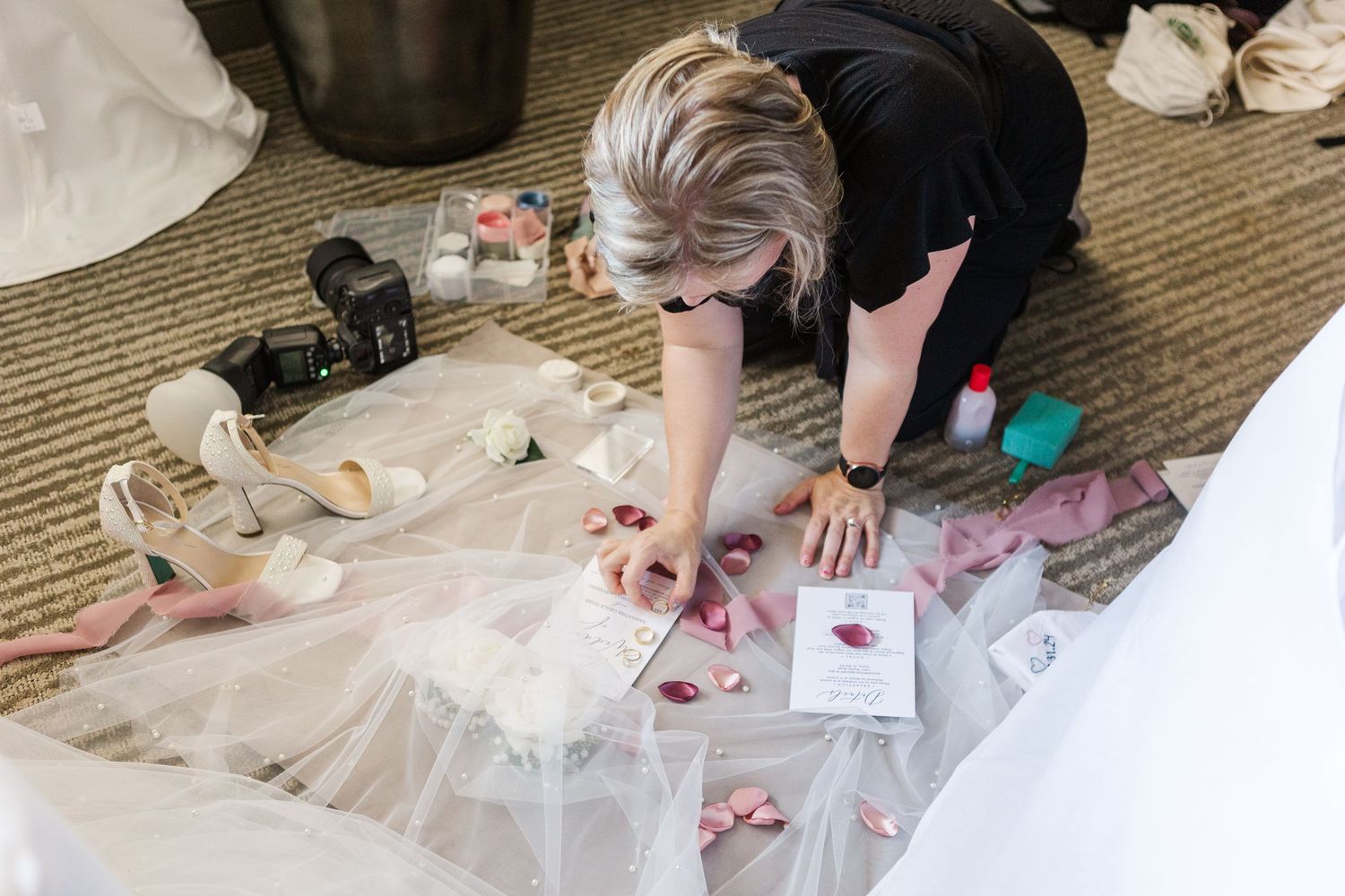 Cassie Lacina styling bridal details on a veil before photographing them