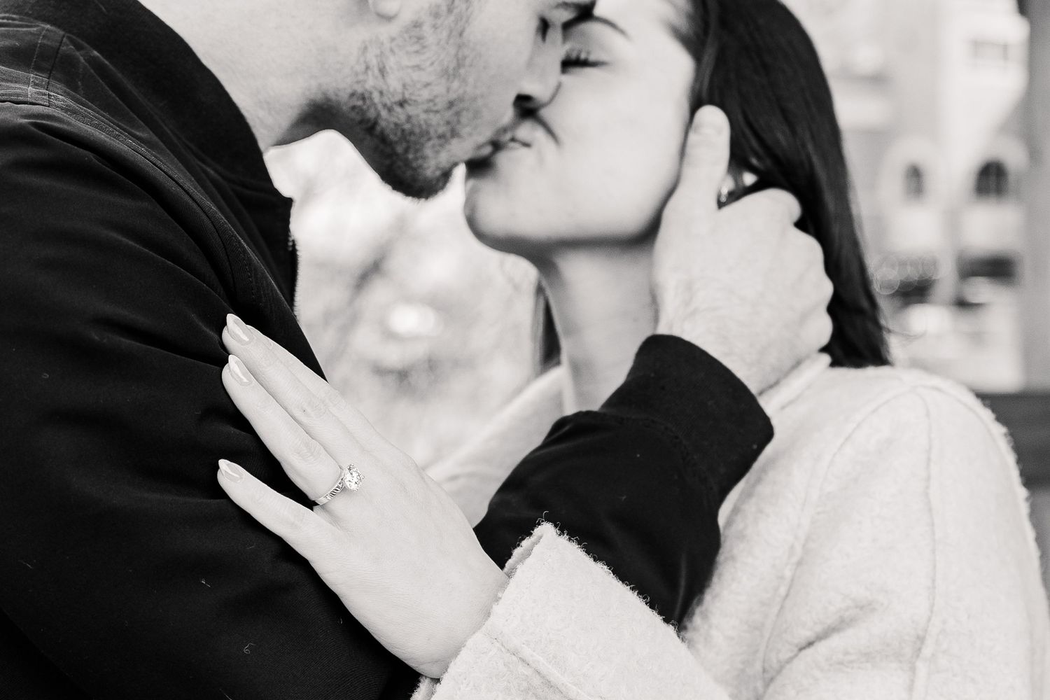 A black and white photo of a couple sharing an intimate moment.