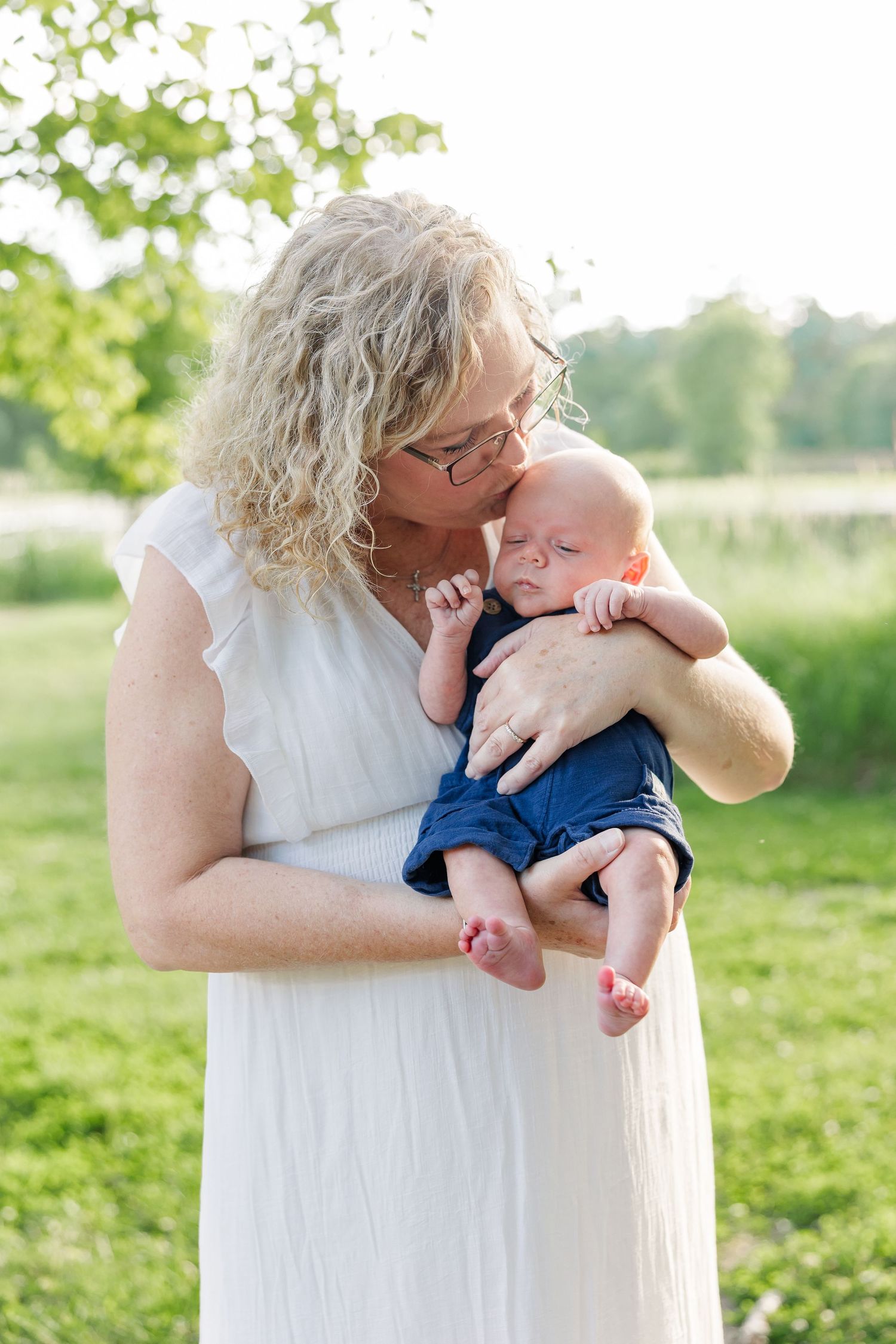 Grandmother cuddling her baby grandson during an extended family session at Veterans Acres Nature Center in Crystal Lake.