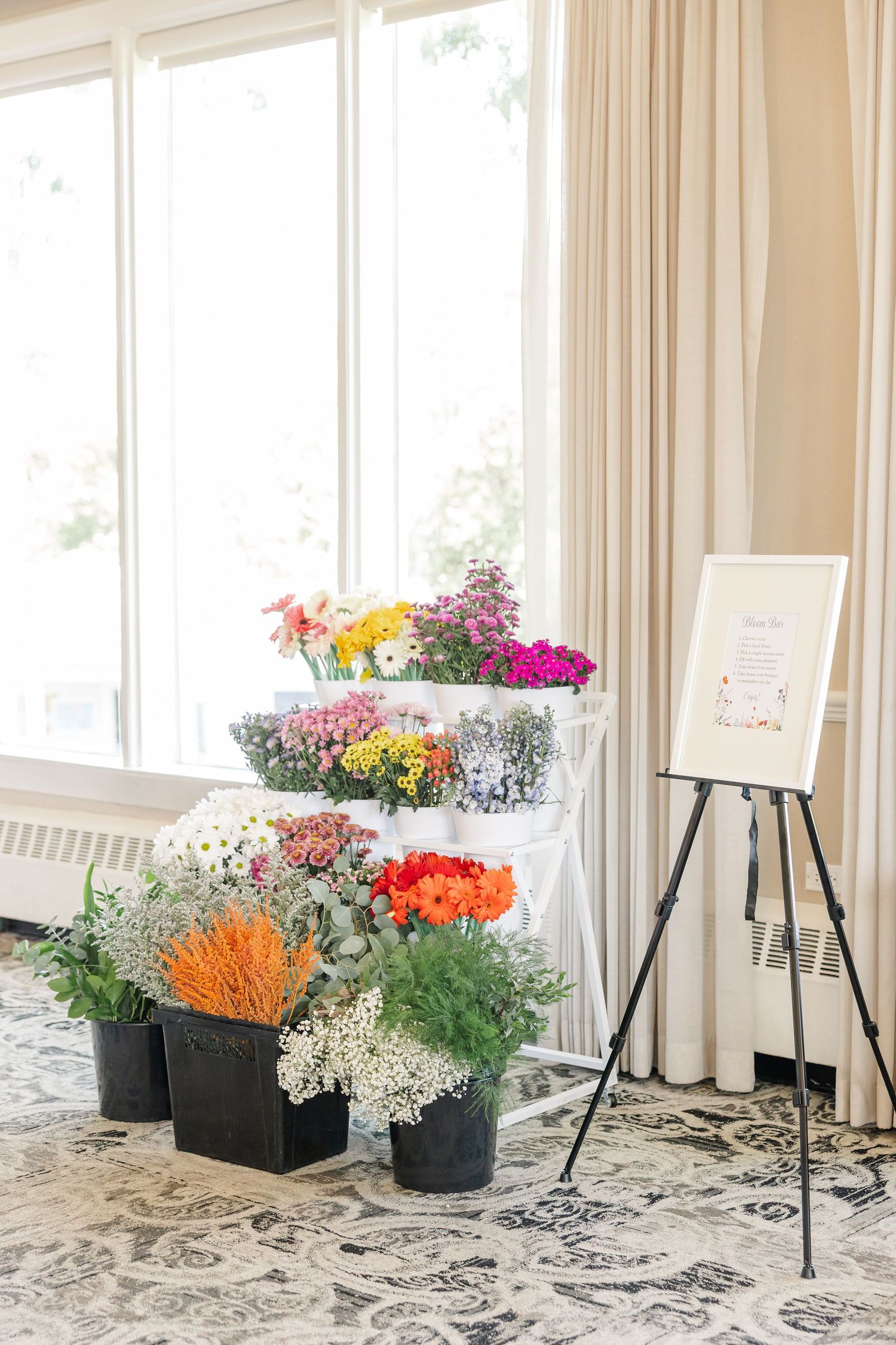 Bloom bar flower buckets and welcome easel at wildflower bridal shower