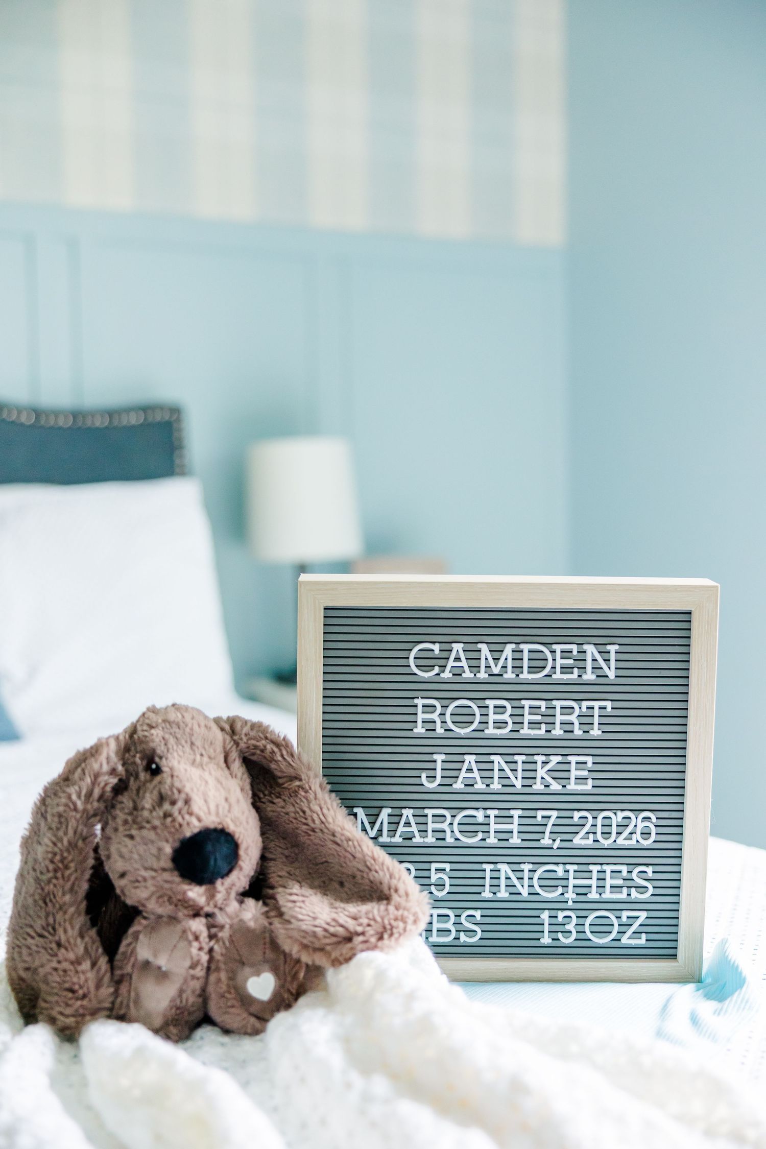 Baby name sign and stuffed bunny during lifestyle newborn session in Crystal Lake, Illinois