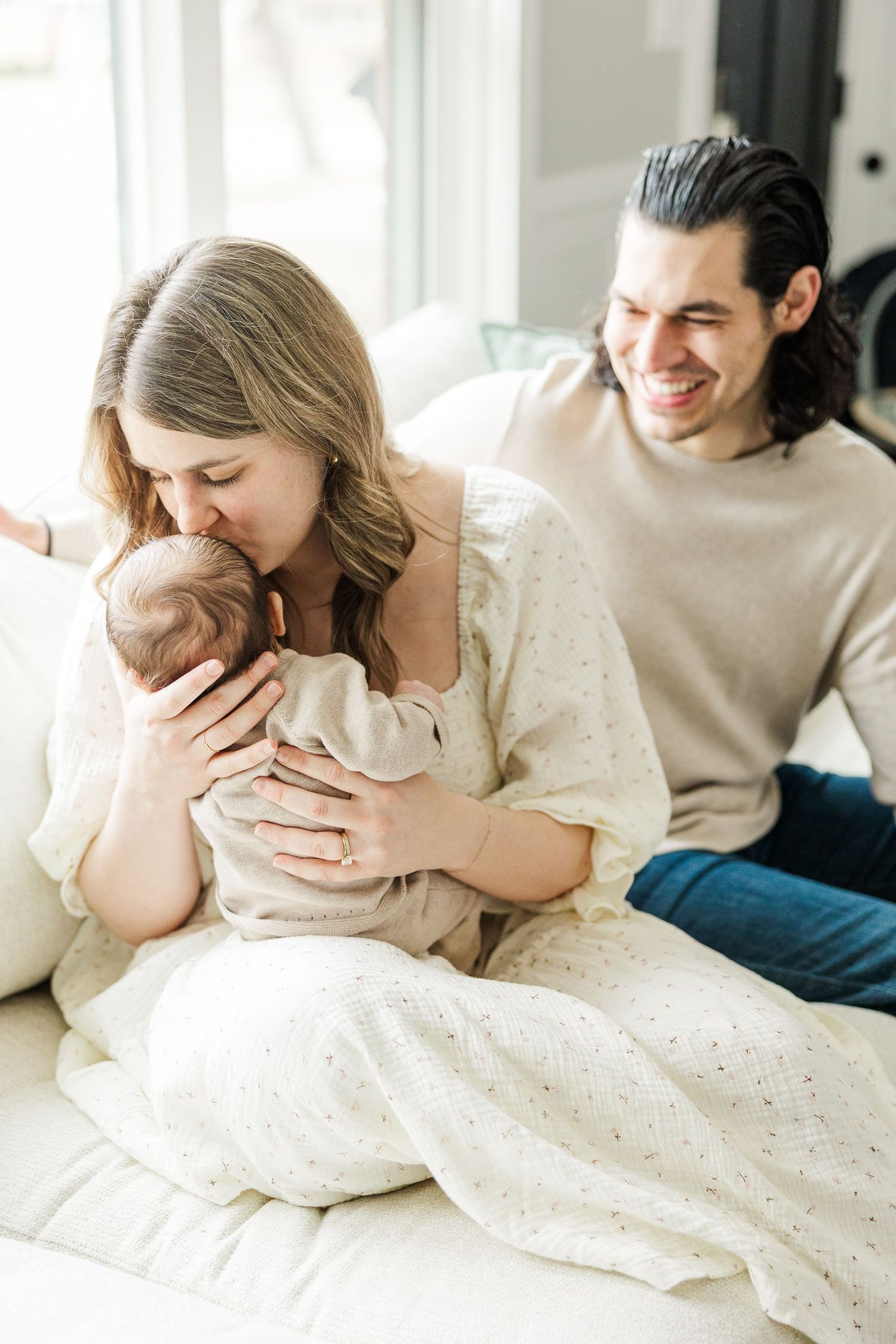 Palatine IL lifestyle newborn photographer capturing a baby cradled in parents’ arms during a natural in-home newborn session
