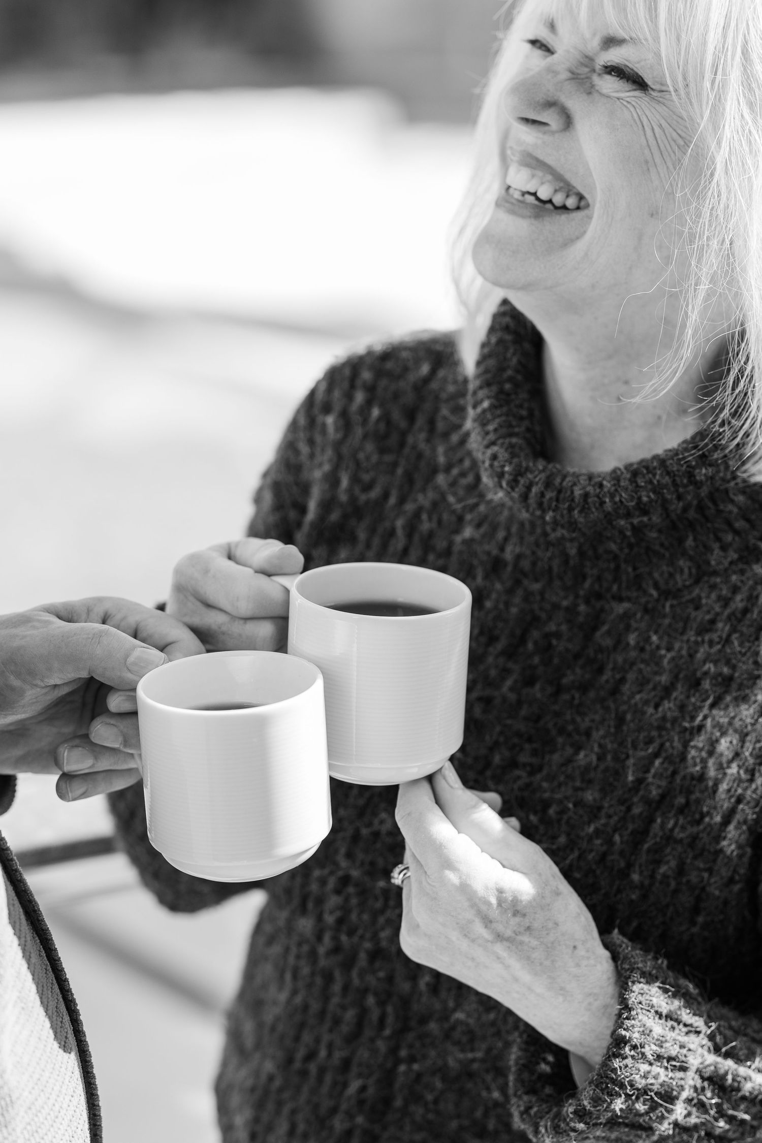 Black and white Beacon Hill senior living branding photo in Lombard, Illinois featuring resident holding coffee