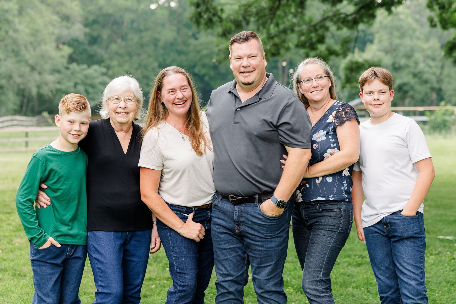 Extended family smiling together outdoors in Bull Valley, Illinois.