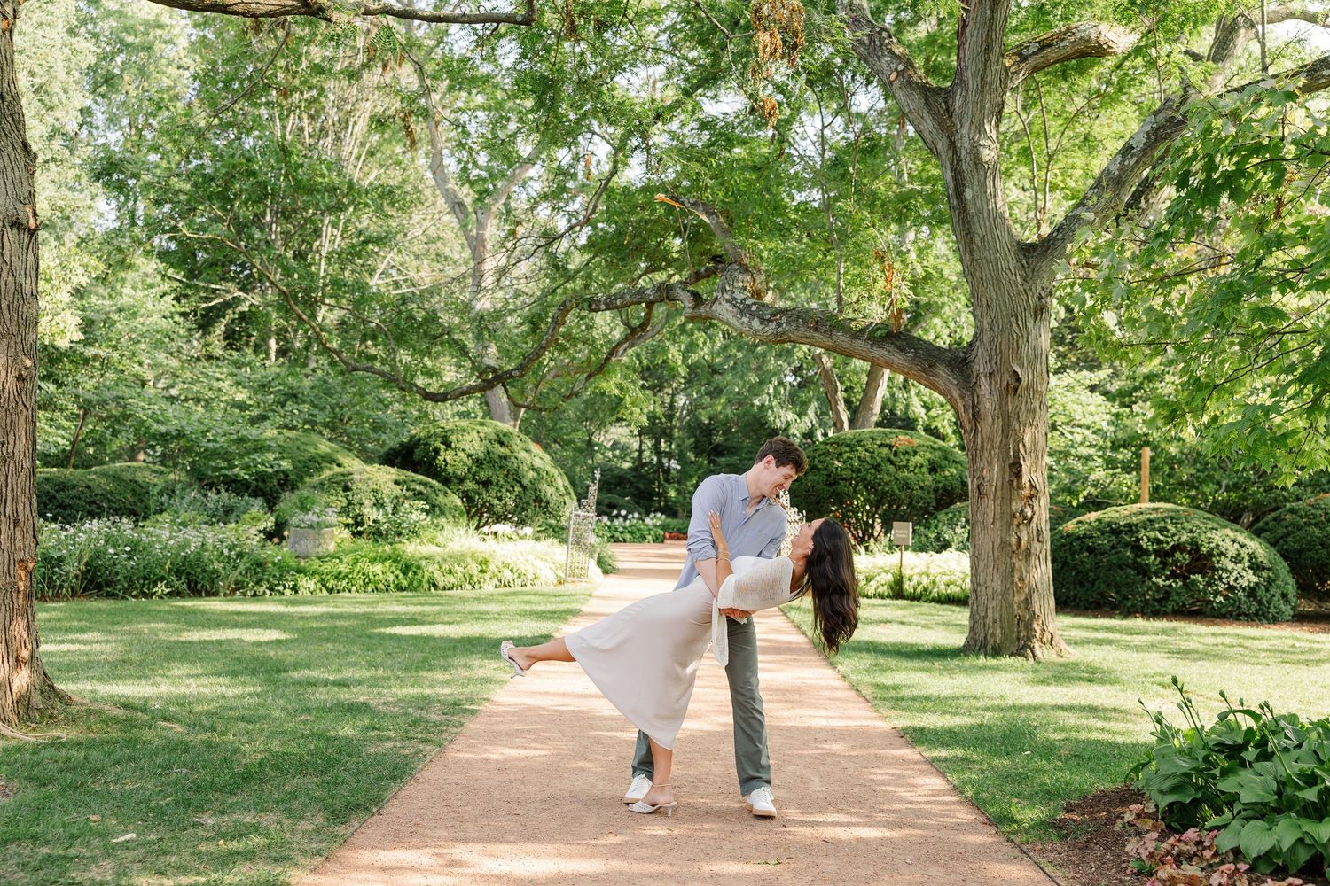 Jack dips Alysia for a kiss beneath the trees in the Cantigny Park gardens.