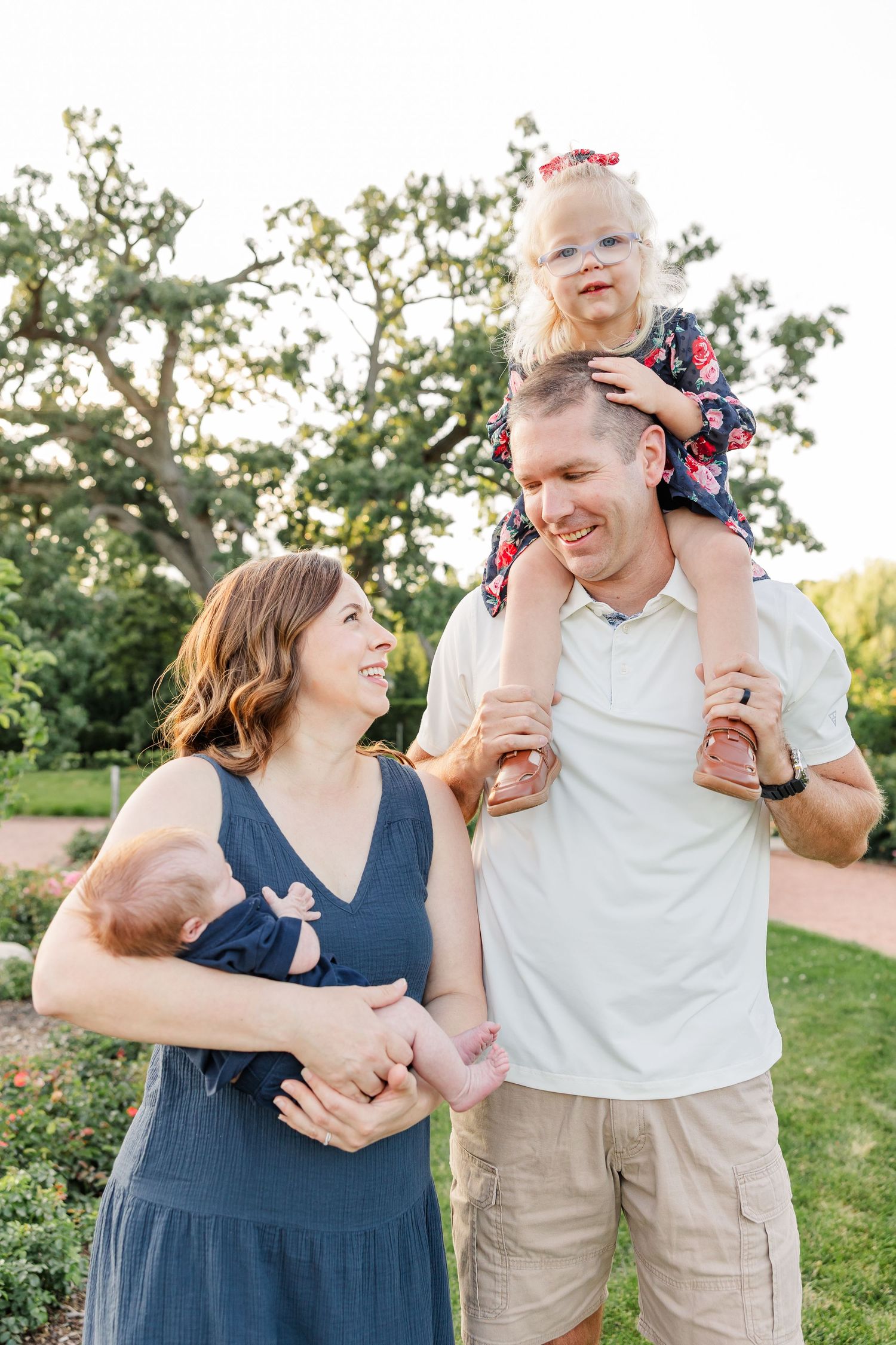 Caroline laughing on Andrew’s shoulders as Hilary holds Lincoln during their Cantigny Park portraits.