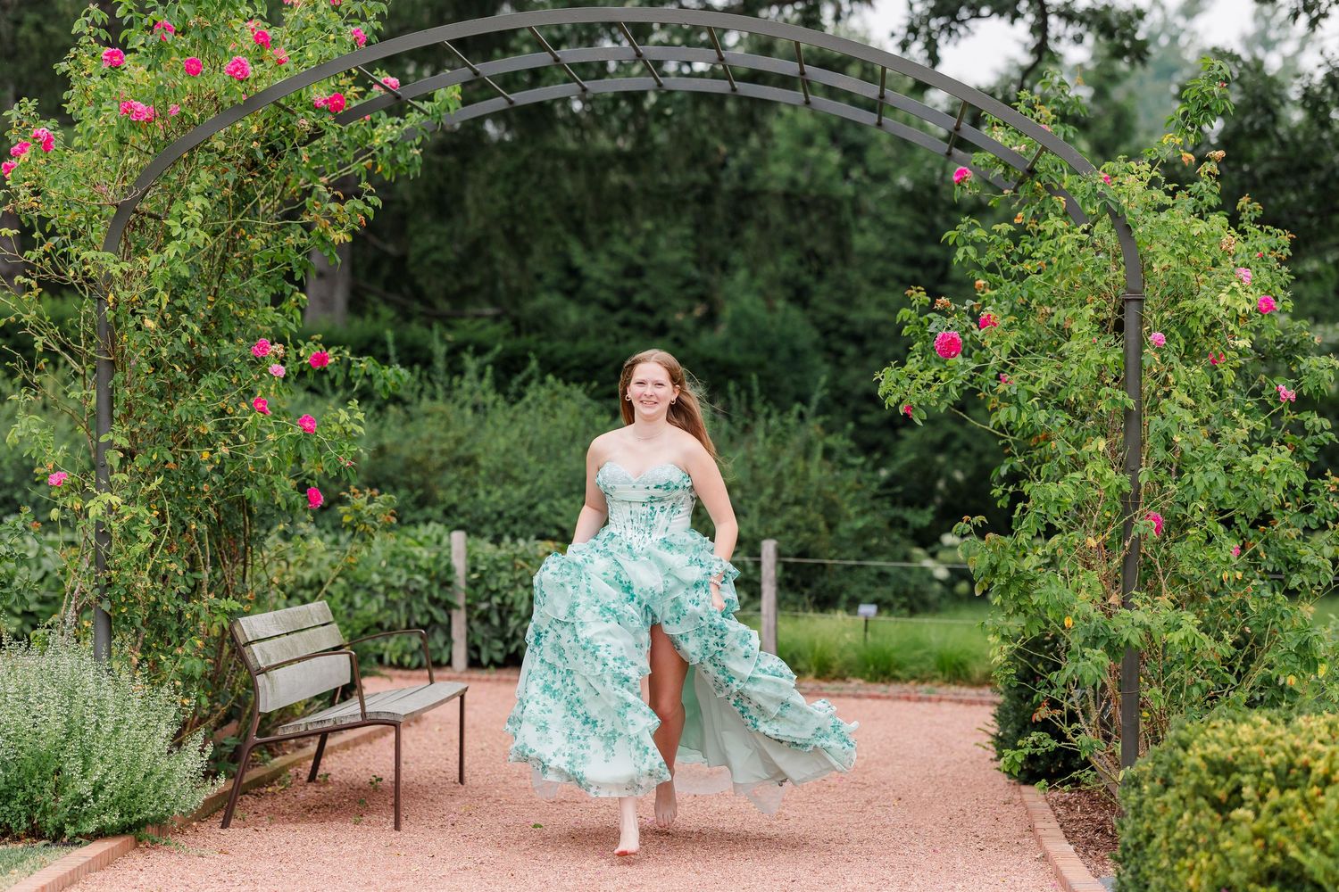 Bartlett High School senior twirls beneath a flower-covered garden arch at Cantigny Park.