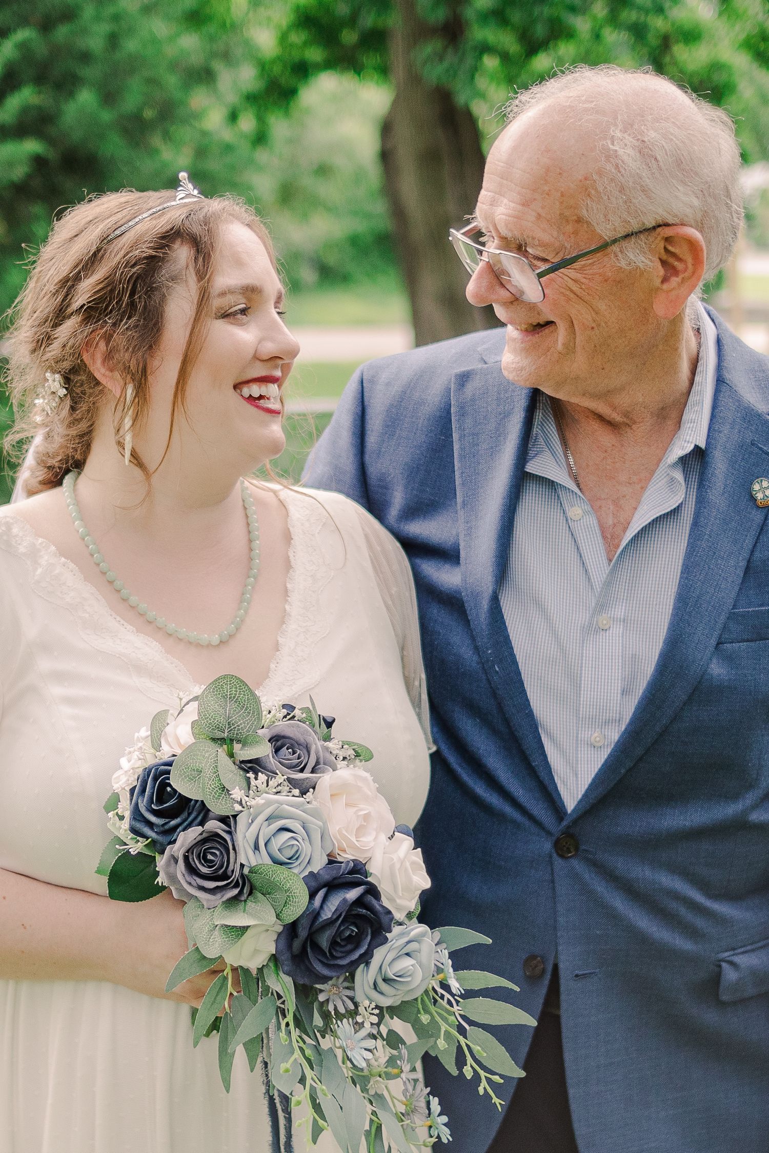 A heartwarming wedding moment shared between two people with a blue and white floral bouquet.