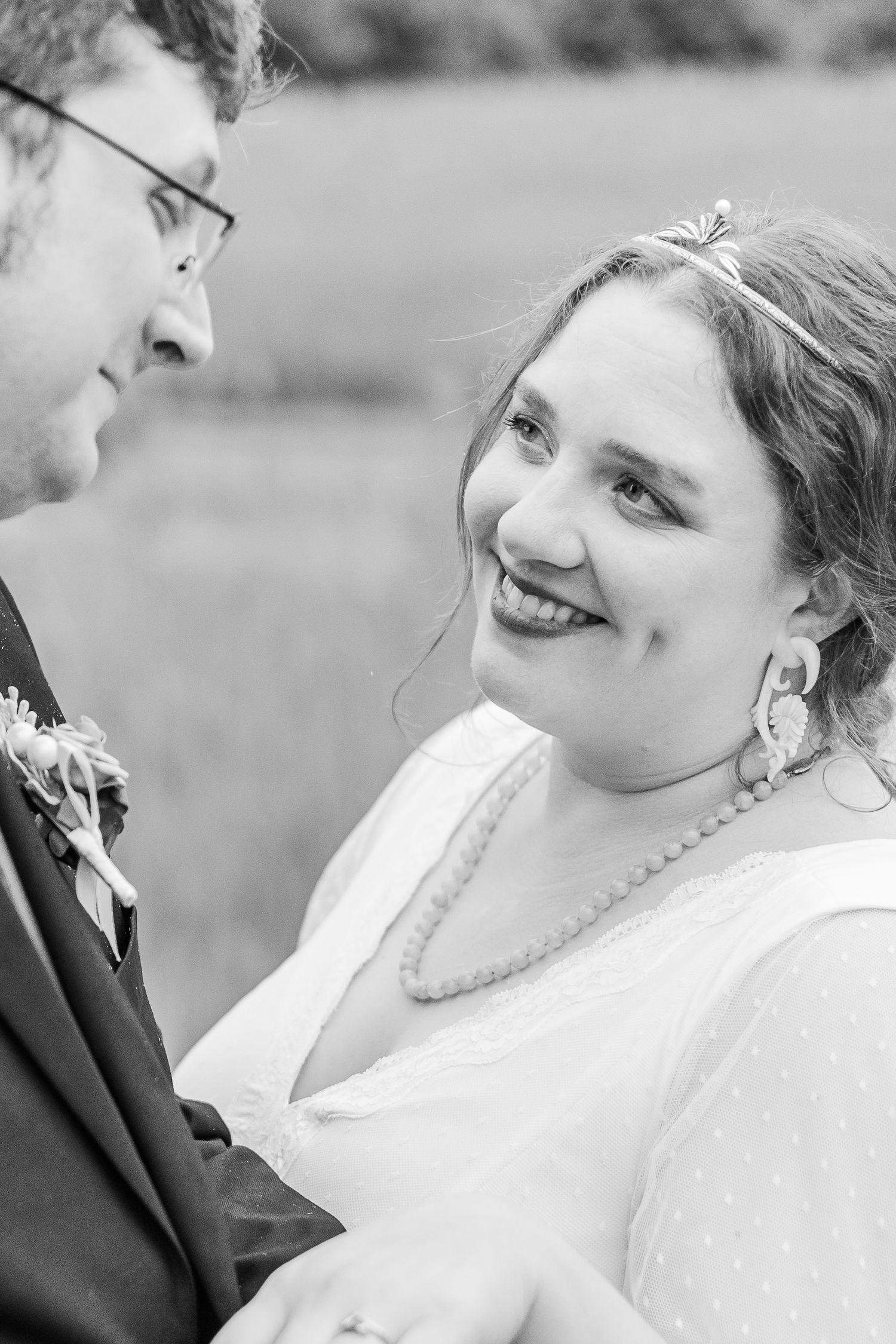 Black and white close-up portrait capturing romantic wedding moment.
