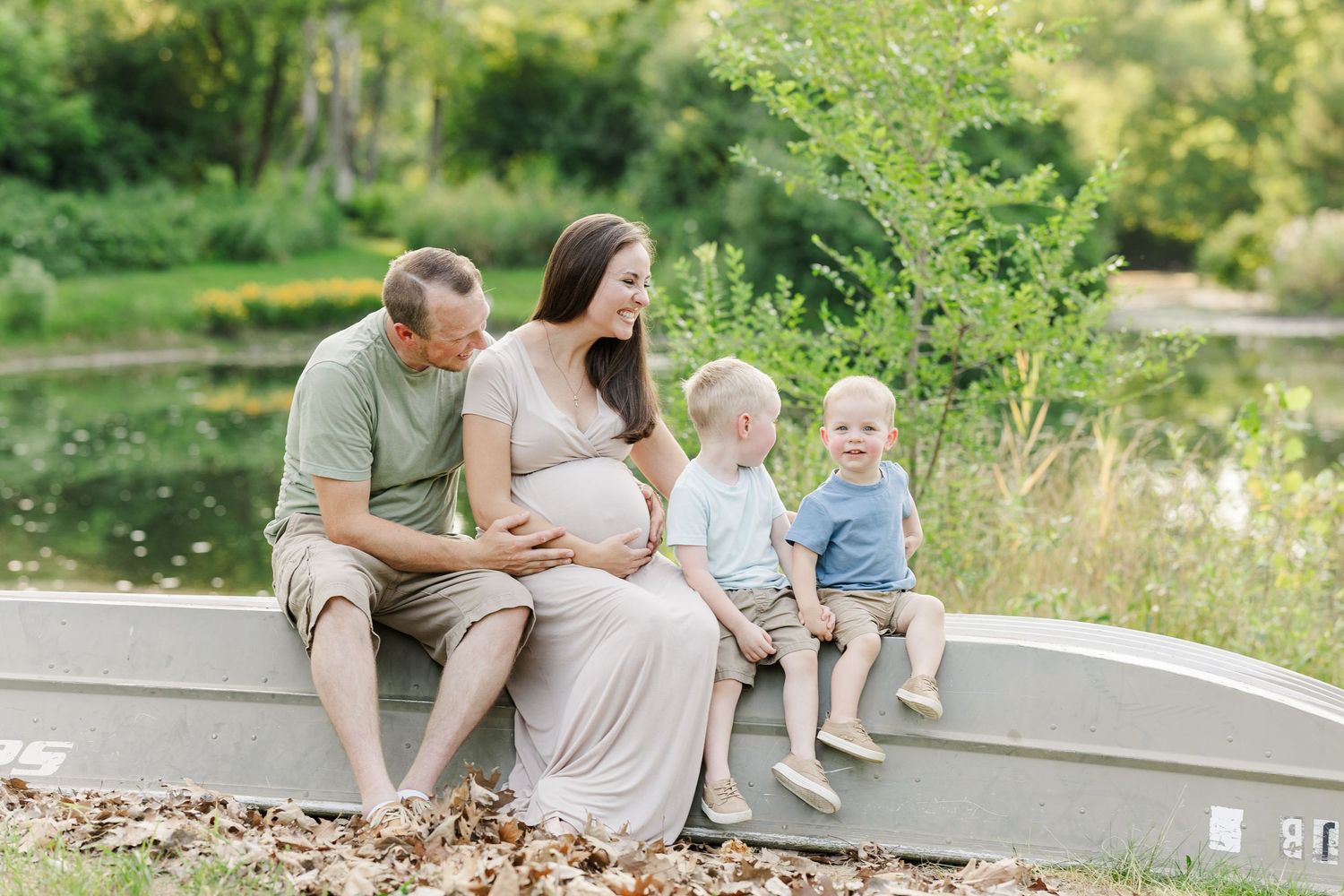 A series of outdoor family portrait photos captured in a natural setting with greenery and sunlight.