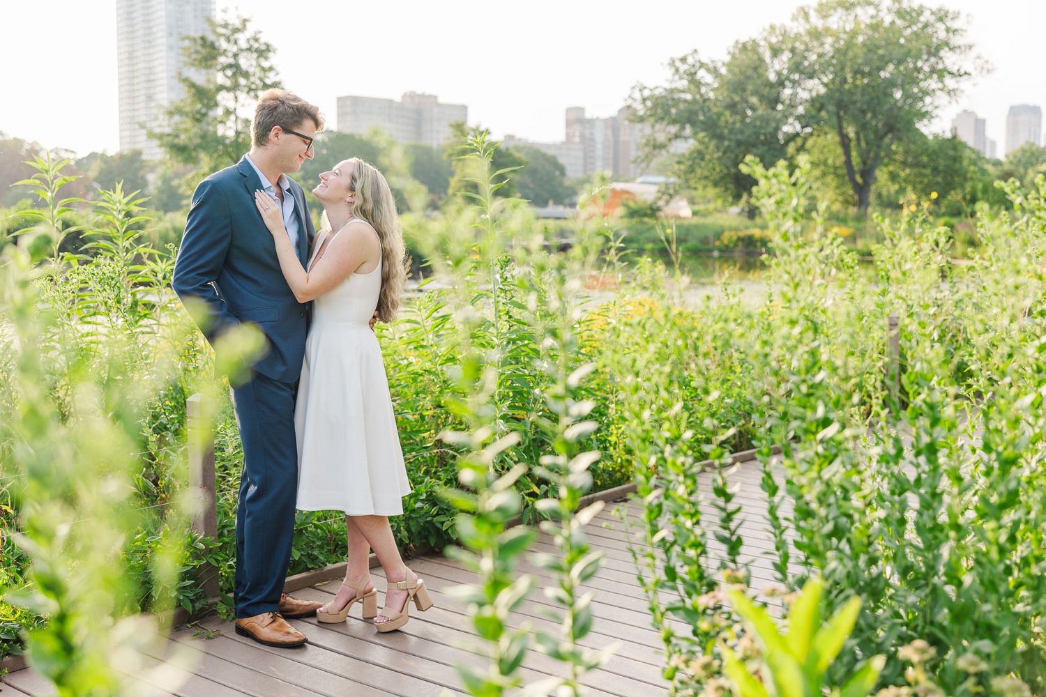 Elizabeth and Joe kissing in the wildflowers on the Lincoln Park Boardwalk in Chicago at sunset