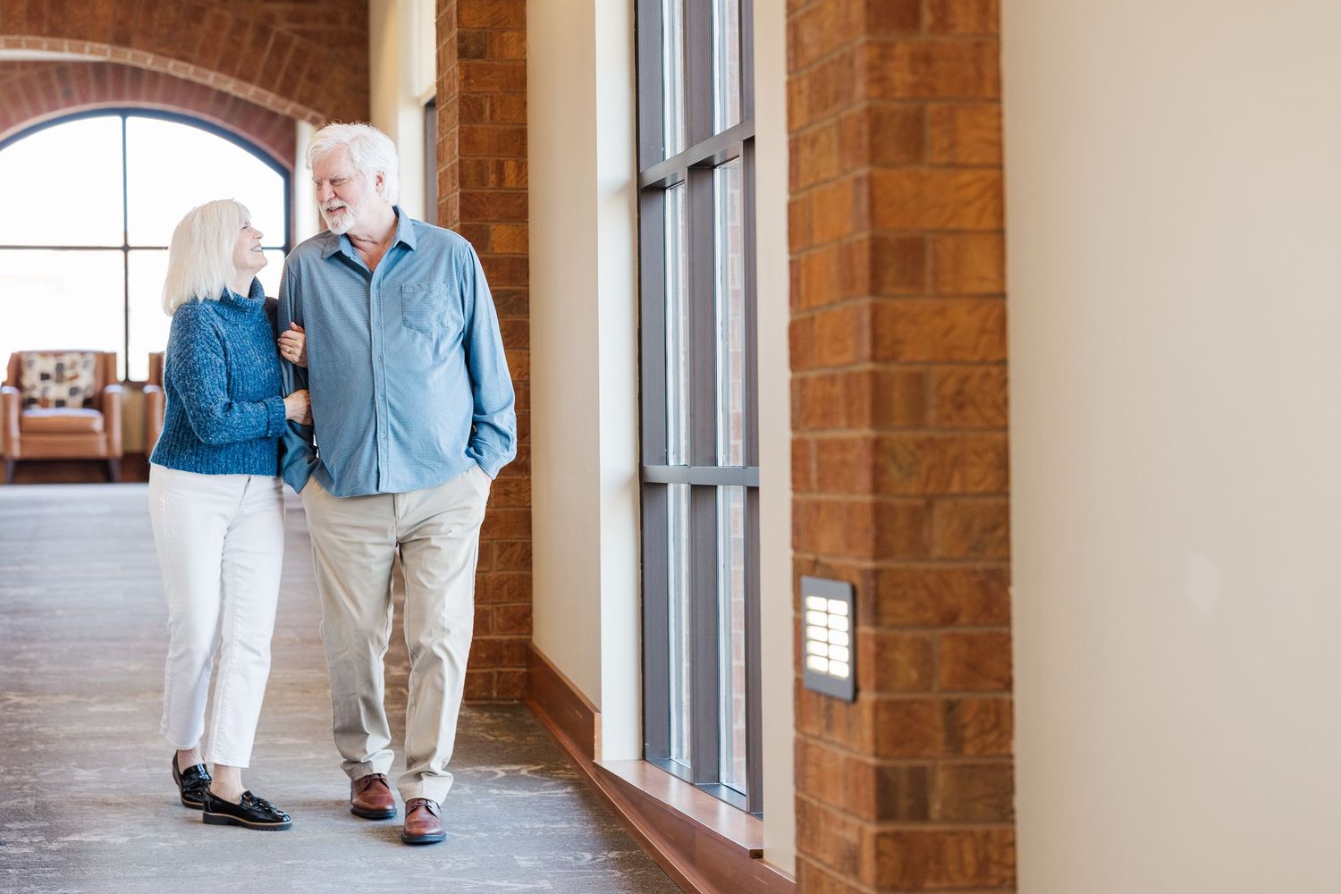 Beacon Hill senior living branding photo in Lombard, Illinois featuring residents walking through hallway
