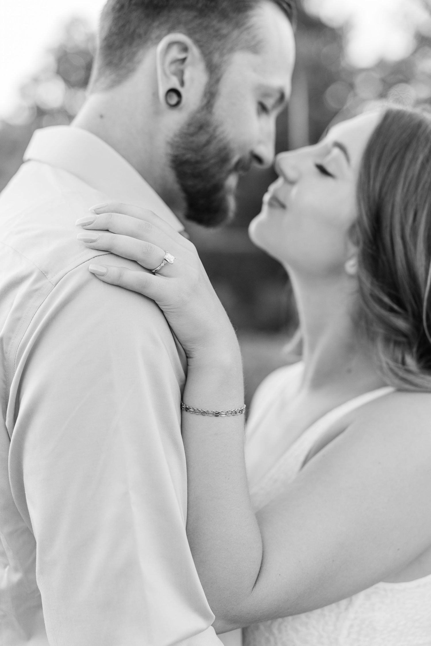 Black and white close-up of couple embracing during engagement photos at Cantigny Park